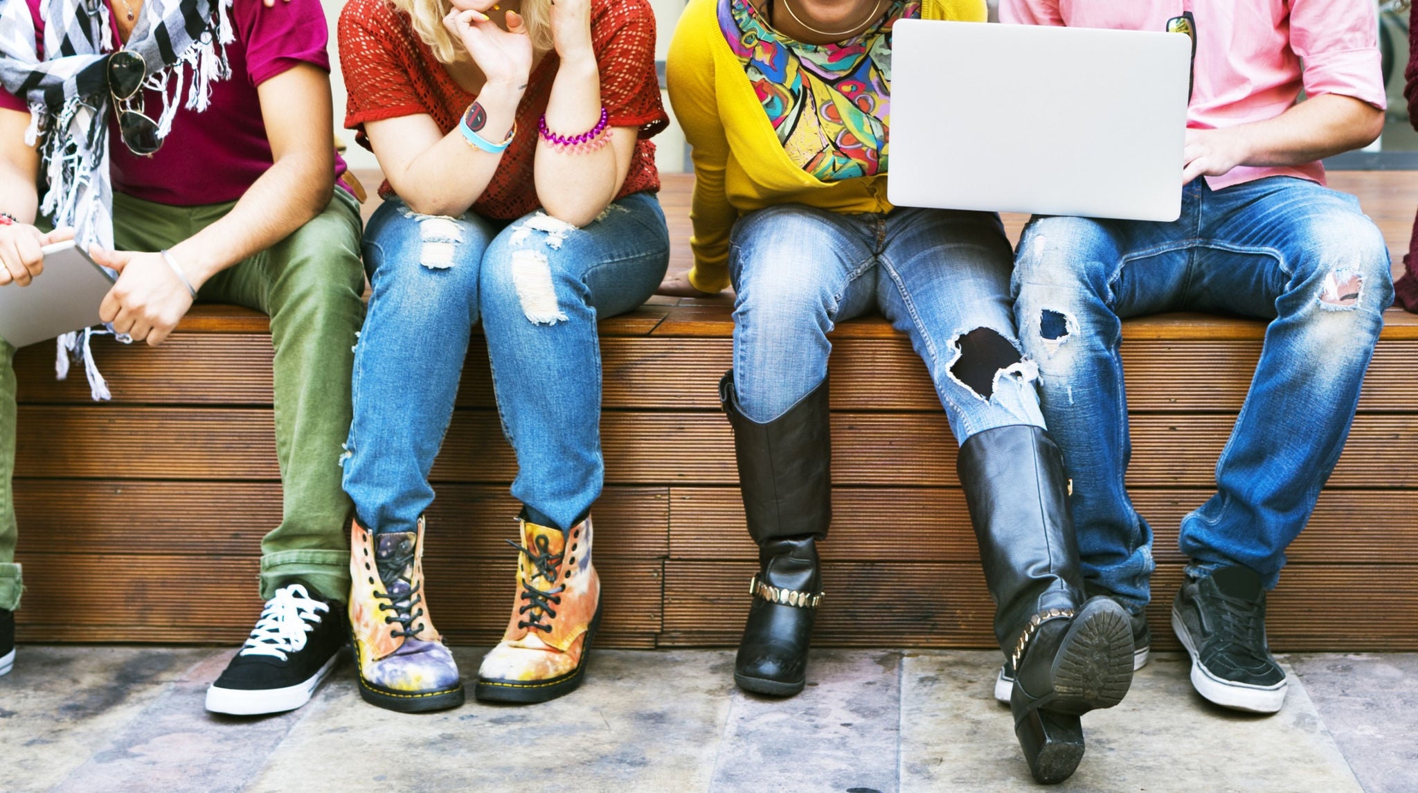 Happy friends gathered on a bench