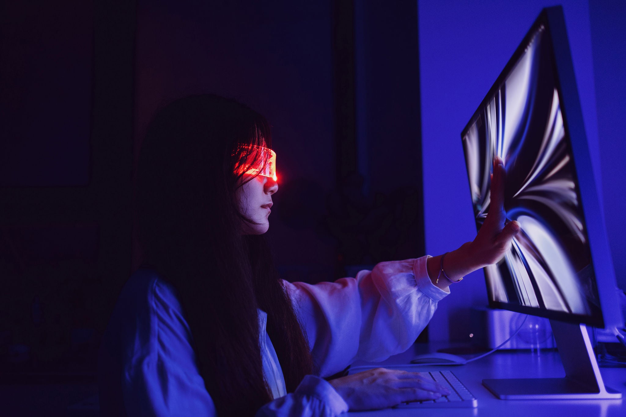 Woman touching computer screen 