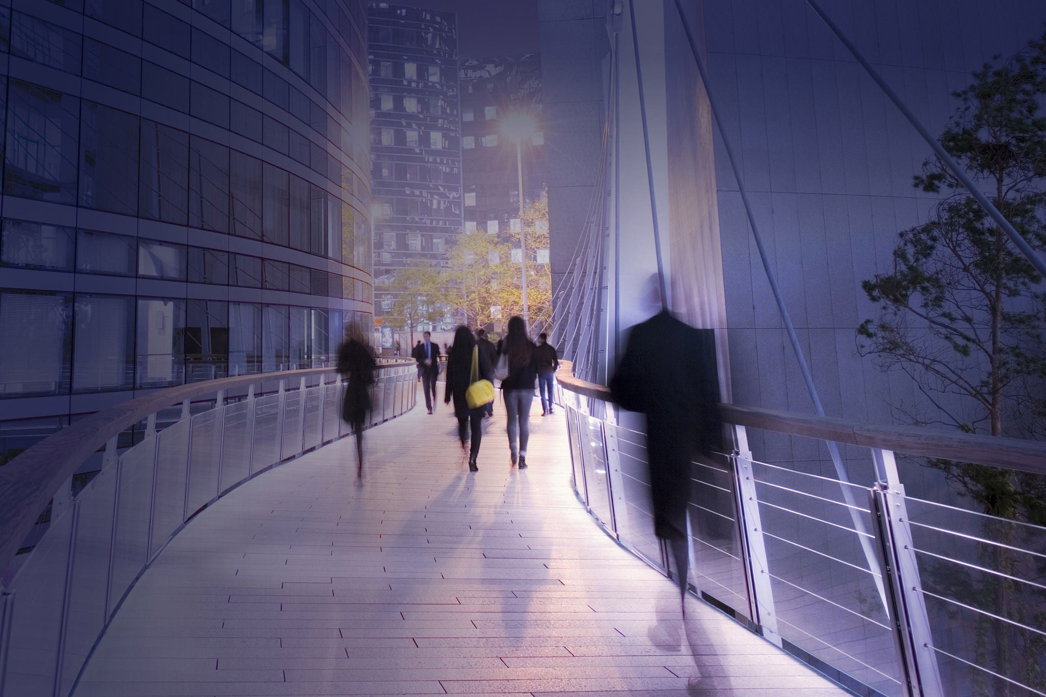 Business people and office workers using walkway at modern business district in Paris, France