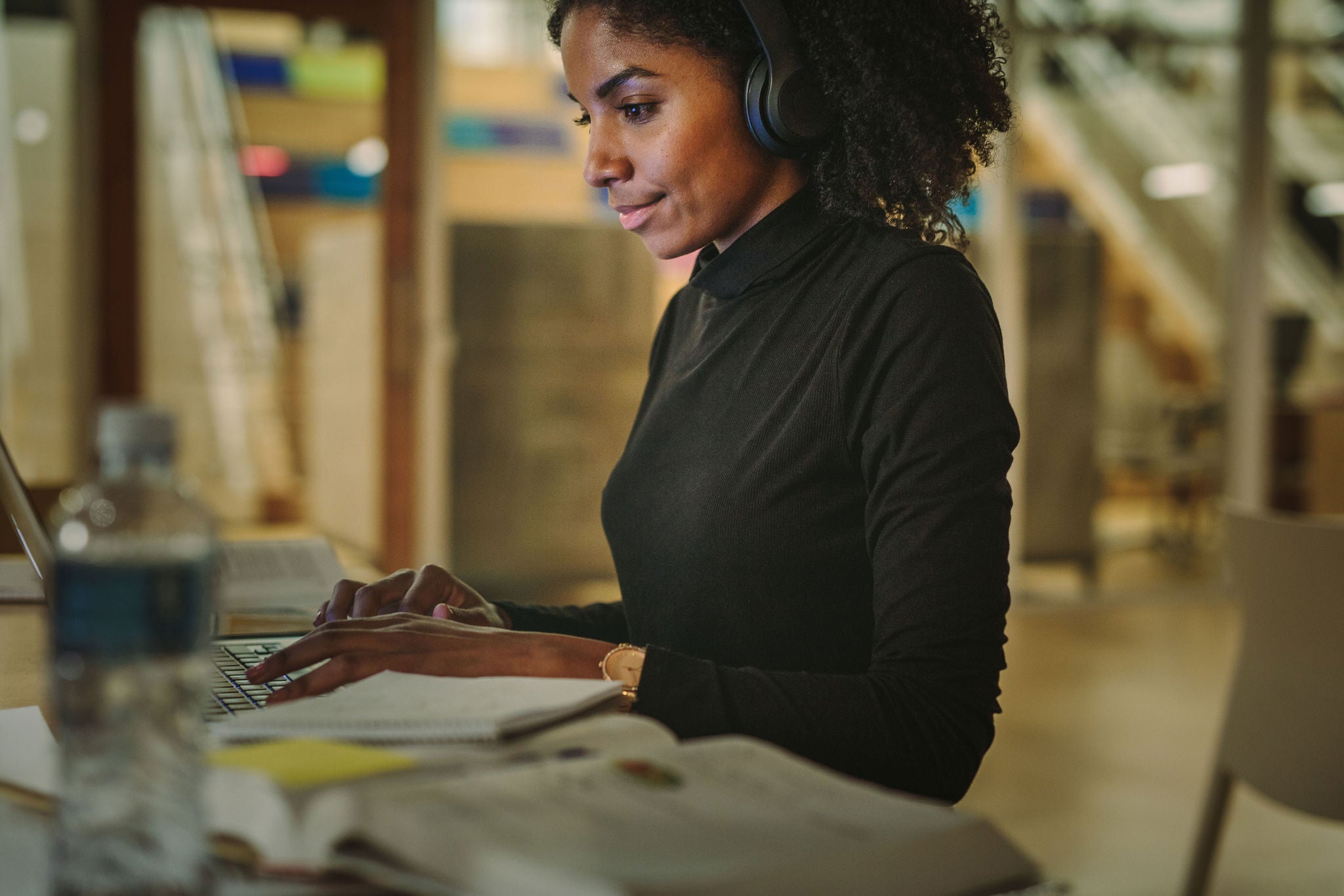 EY young woman with headphones working at night