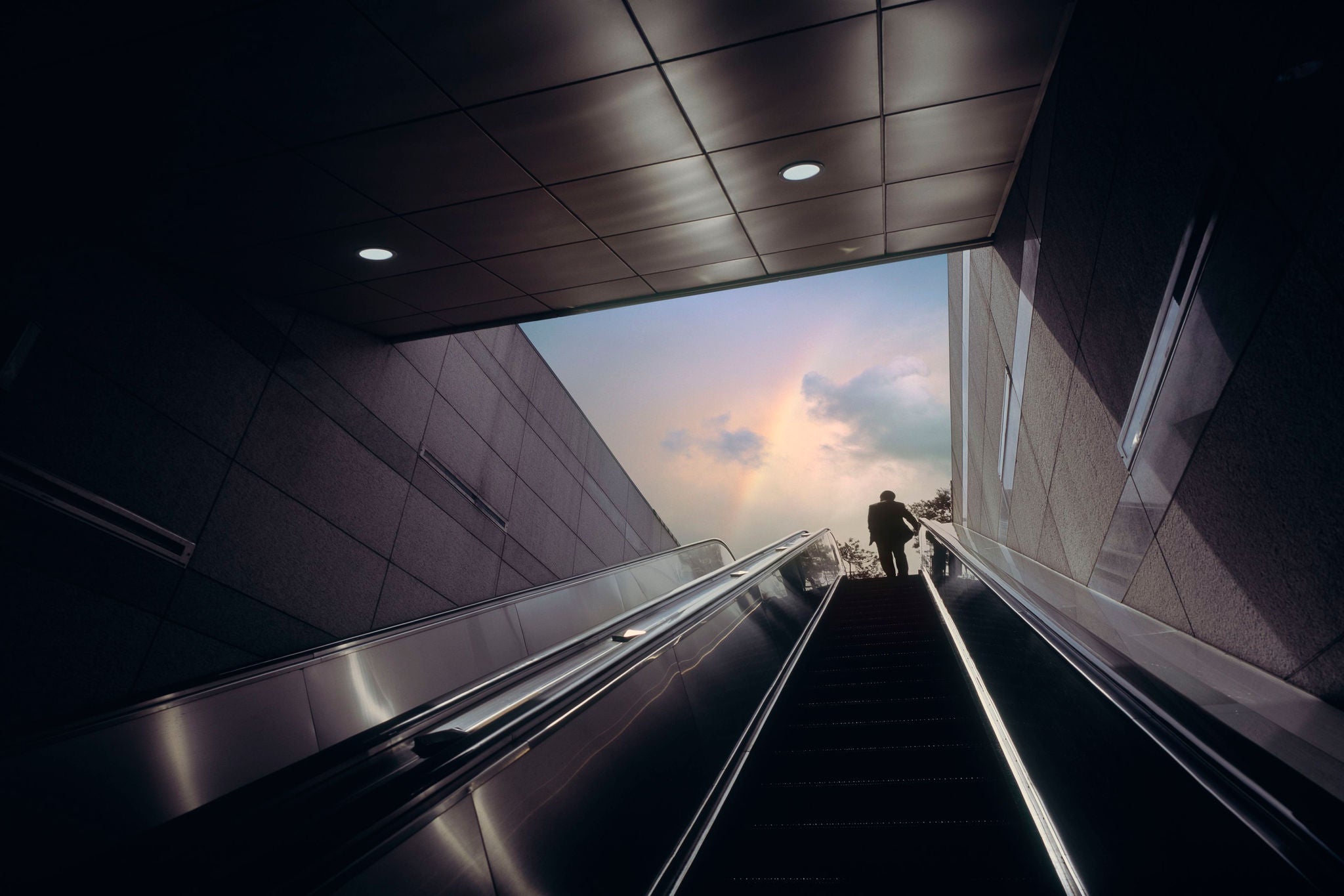 Low angle view of man on escalator