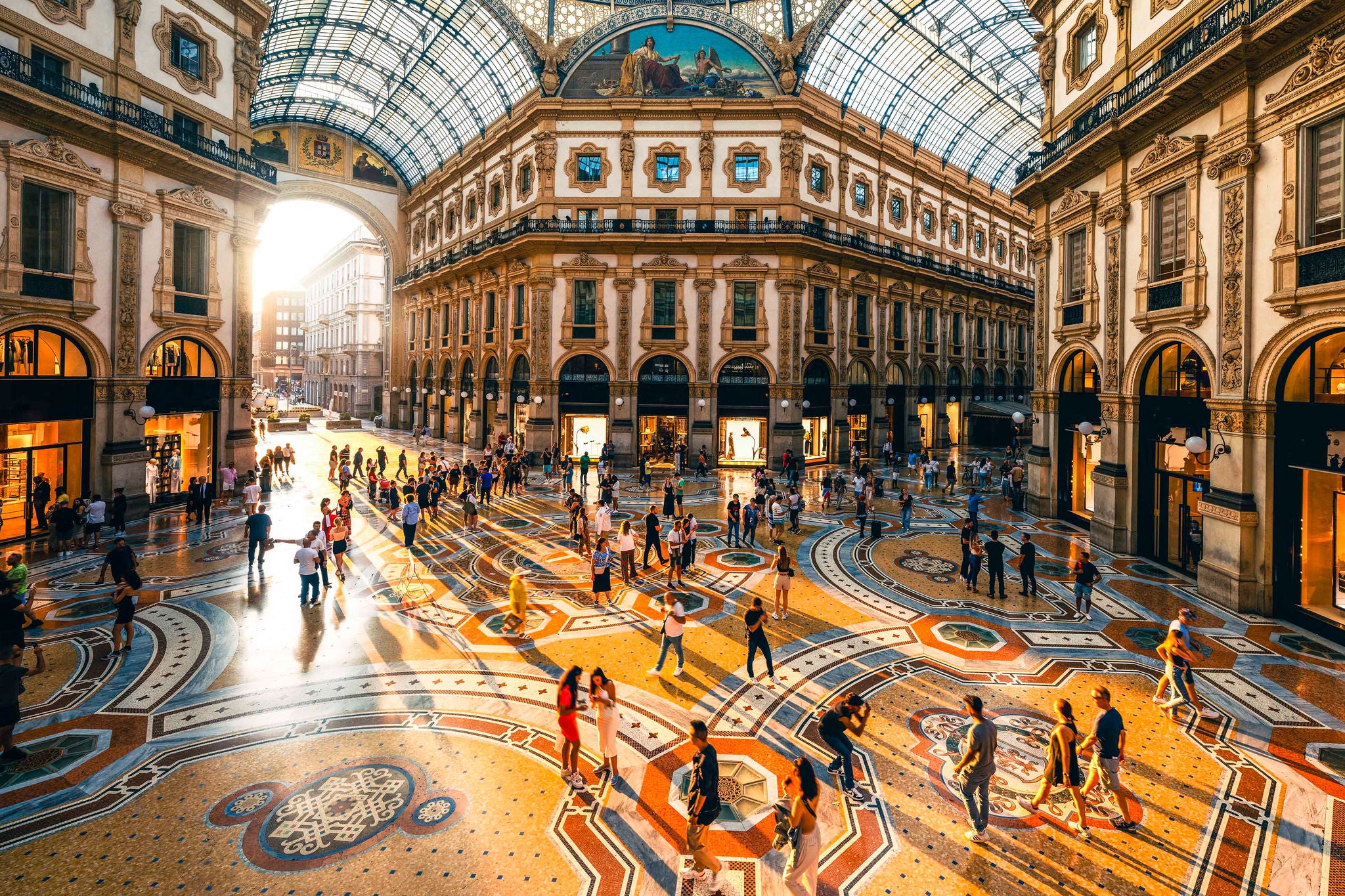 Crowd of people in Galleria Vittorio Emanuele II at sunset