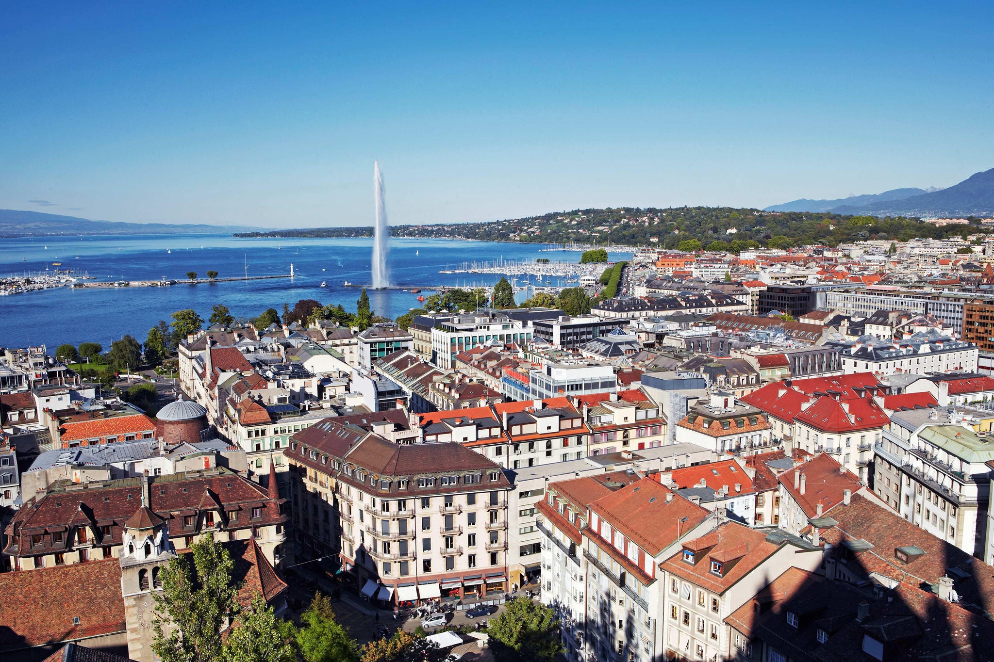 View of downtown Geneva and the iconic 'Jet d'Eau' fountain, a huge water jet situated in Geneva.
