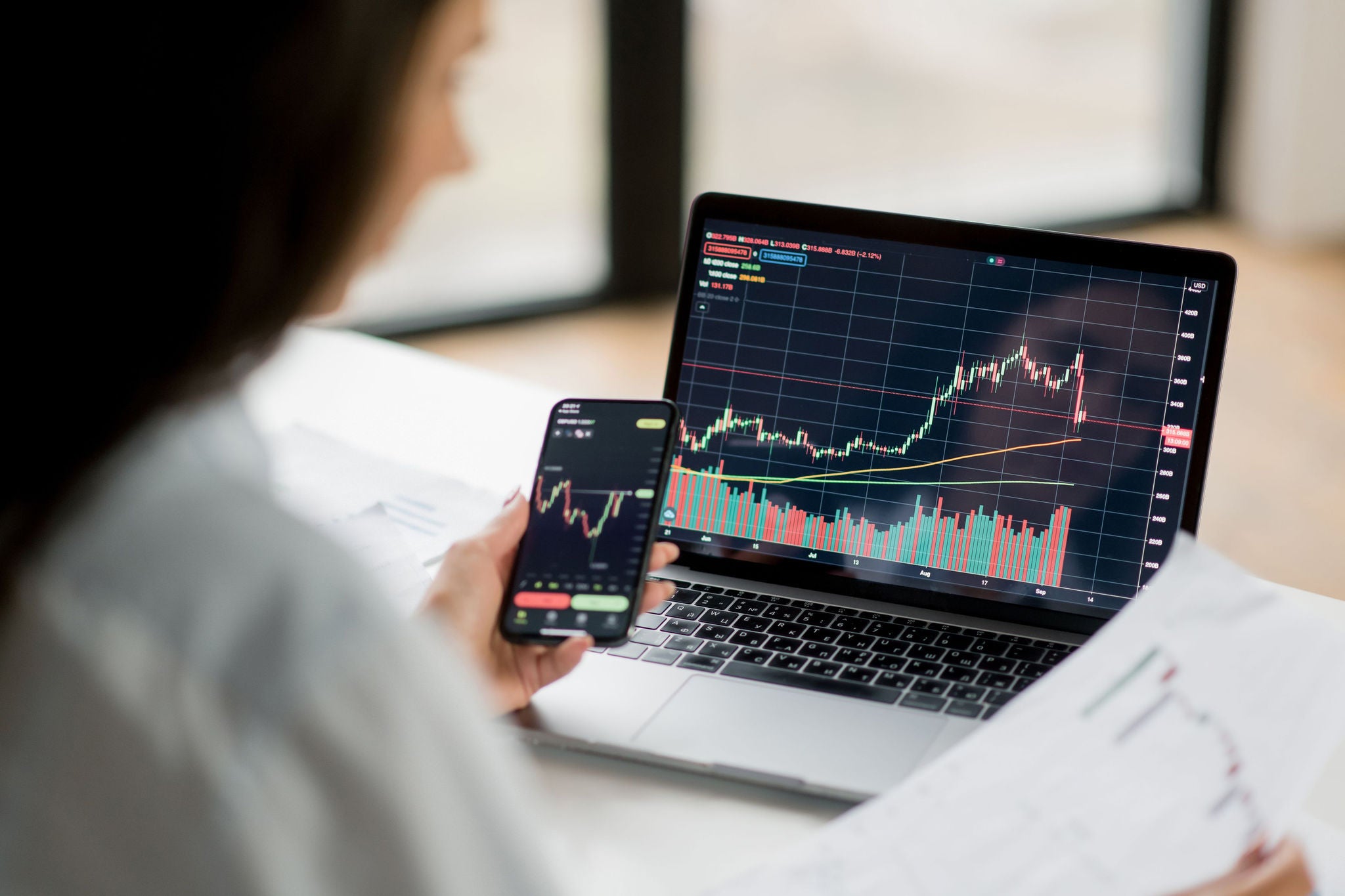 Lady looking at stock market trend in laptop