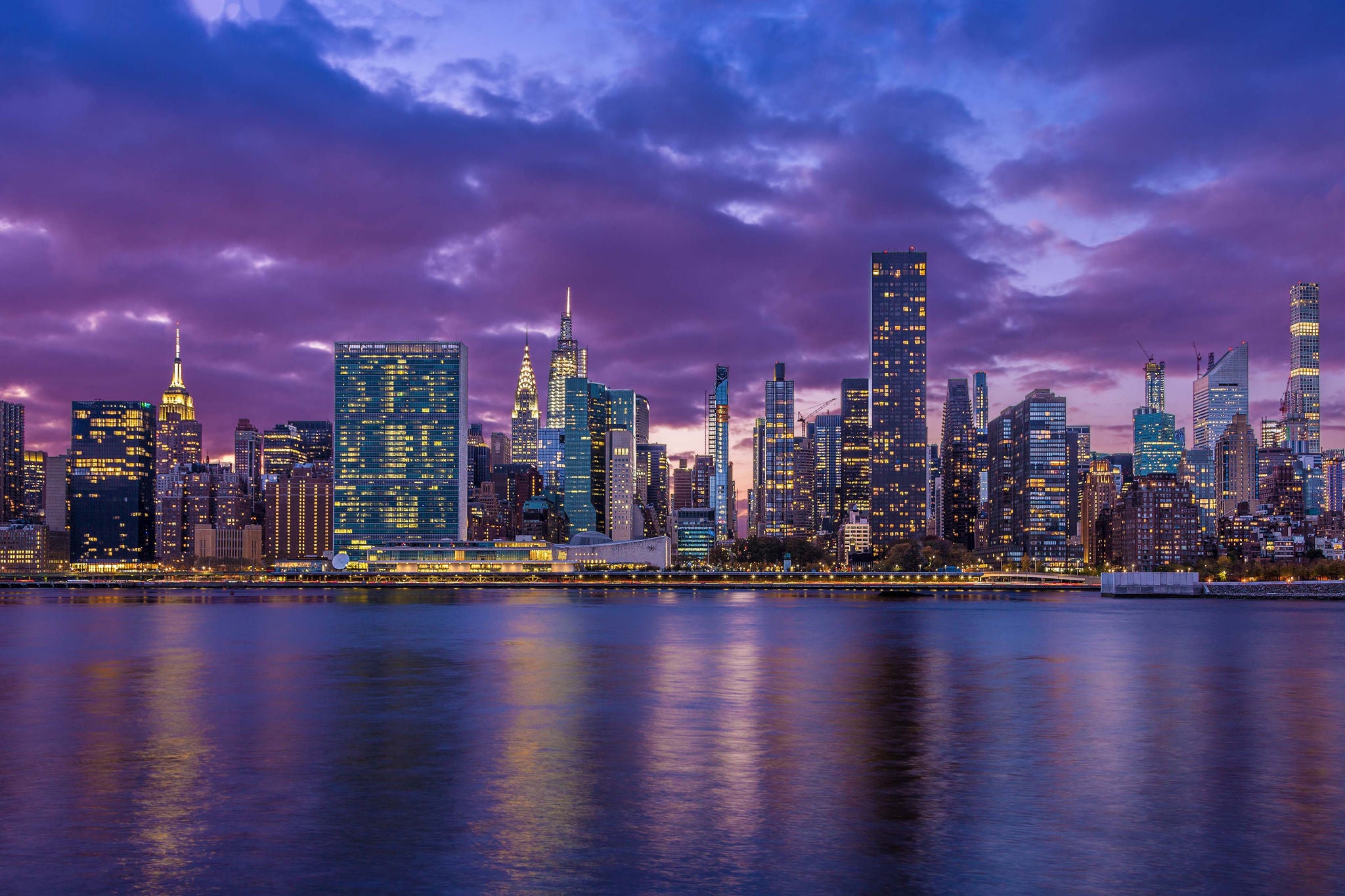 Skyscrapers of the Manhattan East Side and Water of East River Illuminated at Sunset, as seen from Gantry Plaza Park in Queens, New York, USA. Canon EOS 6D (full frame sensor) DSLR and Canon EF 24-105mm F/4L IS lens.