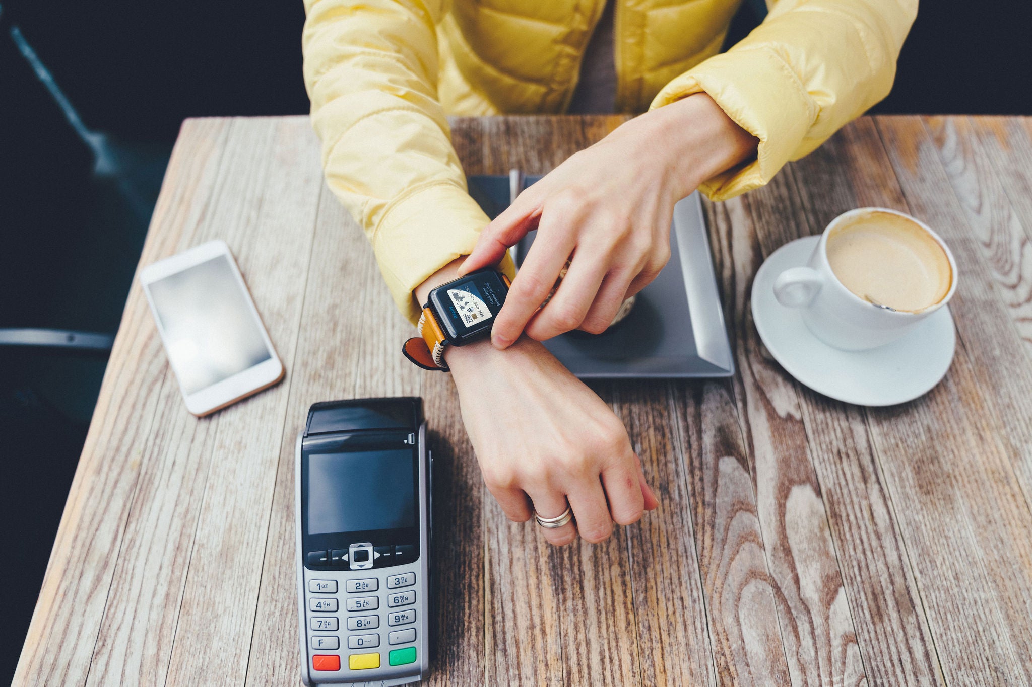 Tourist at cafe paying contactless