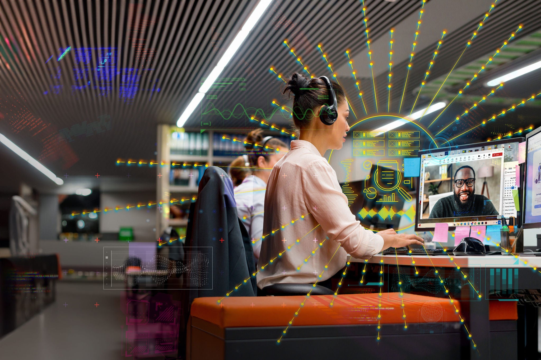 Group of customer service representatives working at a call center using headsets and their computers. image on screen of customer is Adobe Stock 359417856