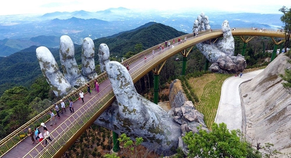 Drone view of road built between hands statue