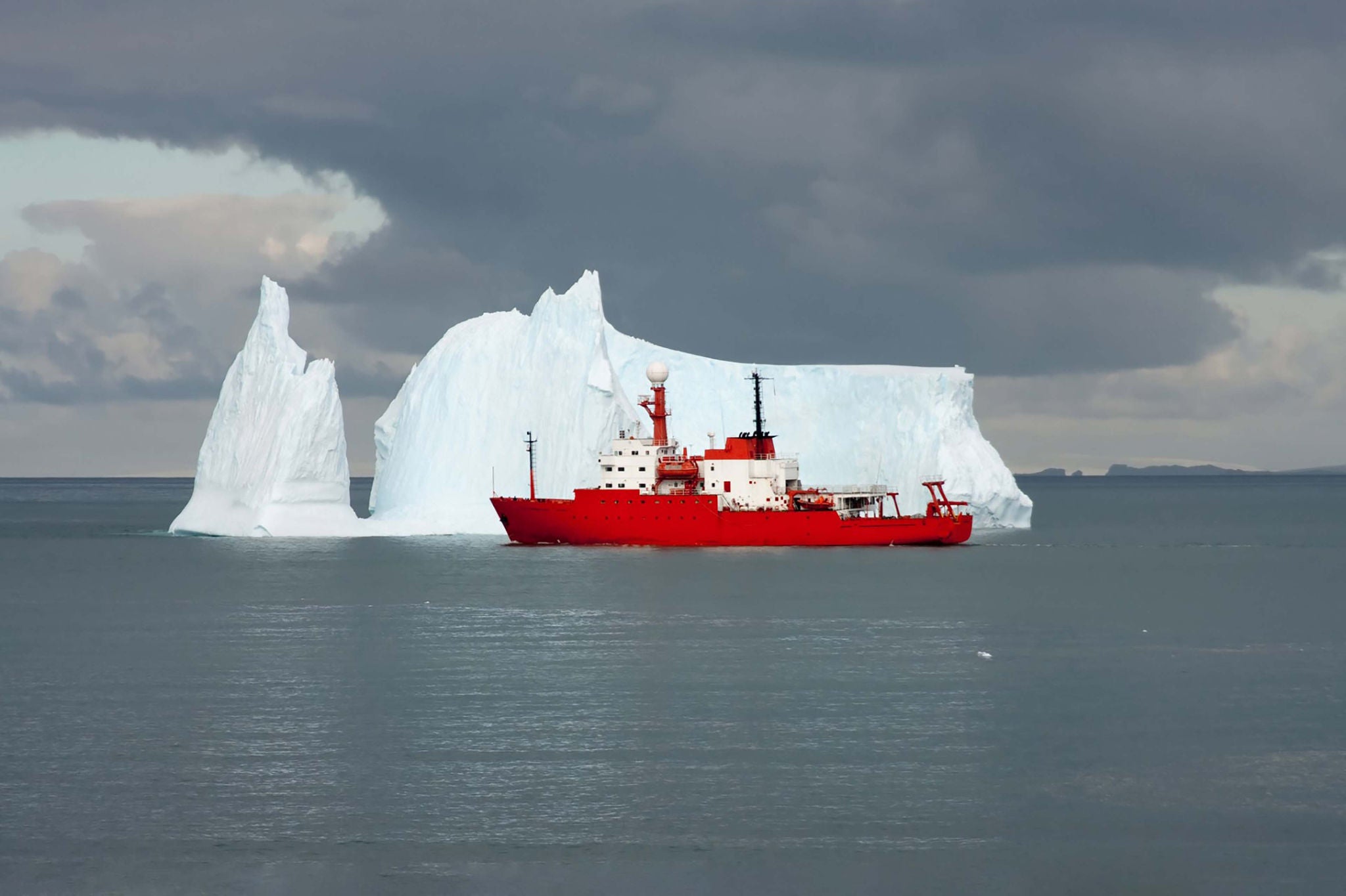 Ice burg and red boat