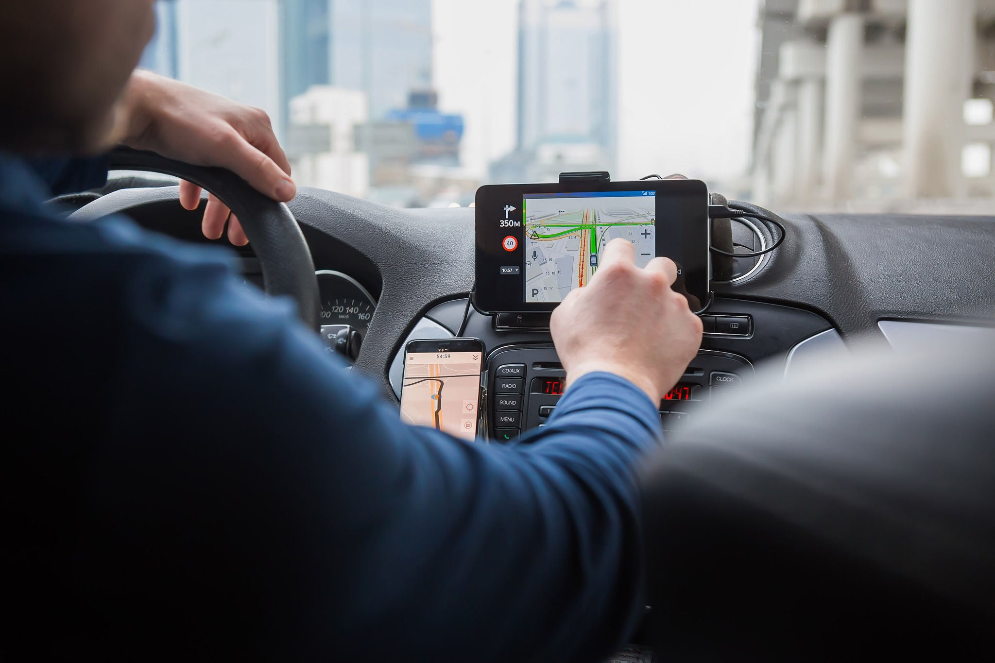 Driver in the car controls the navigator. Close-up part