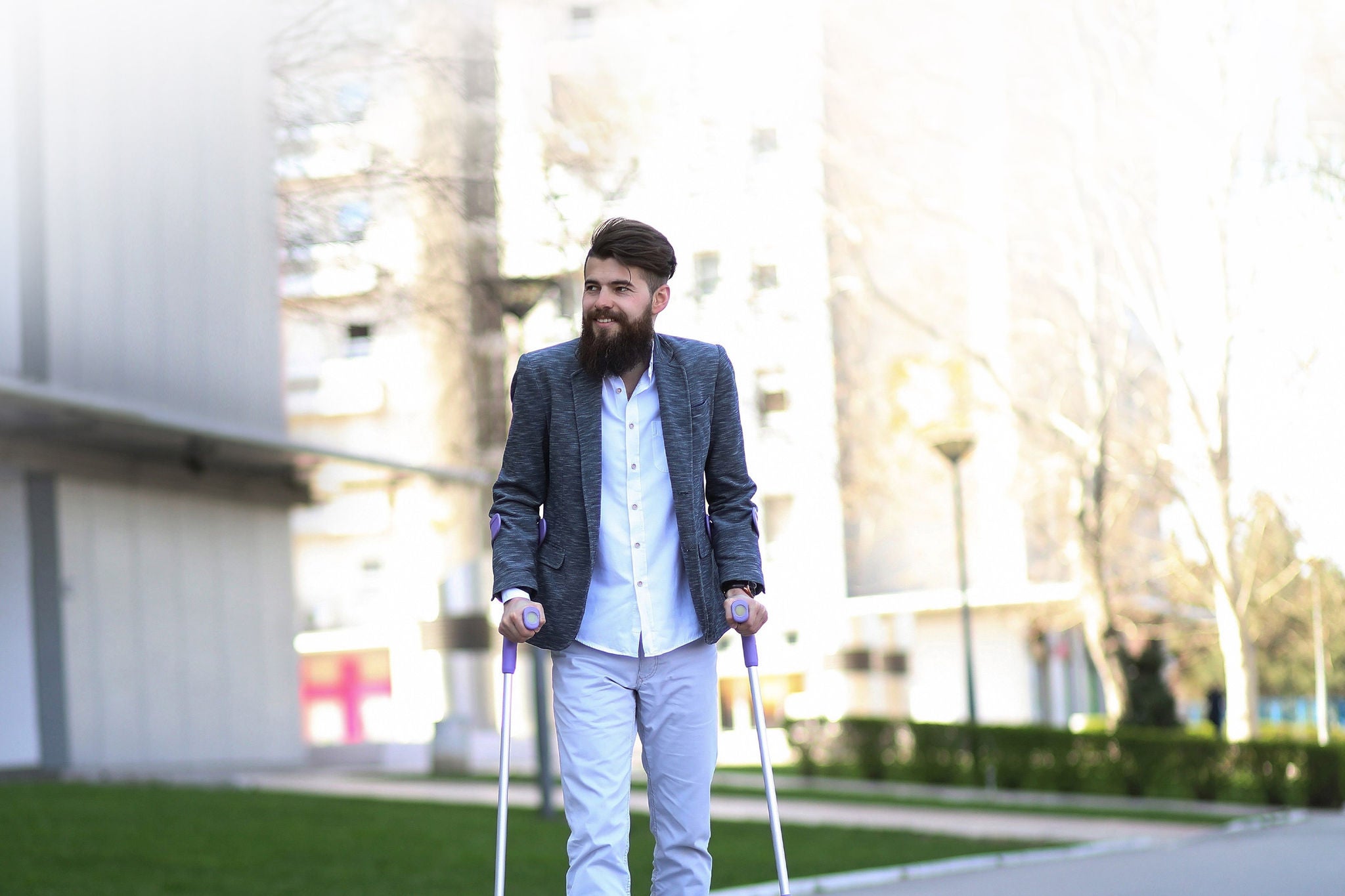 Young man with walking sticks outdoors