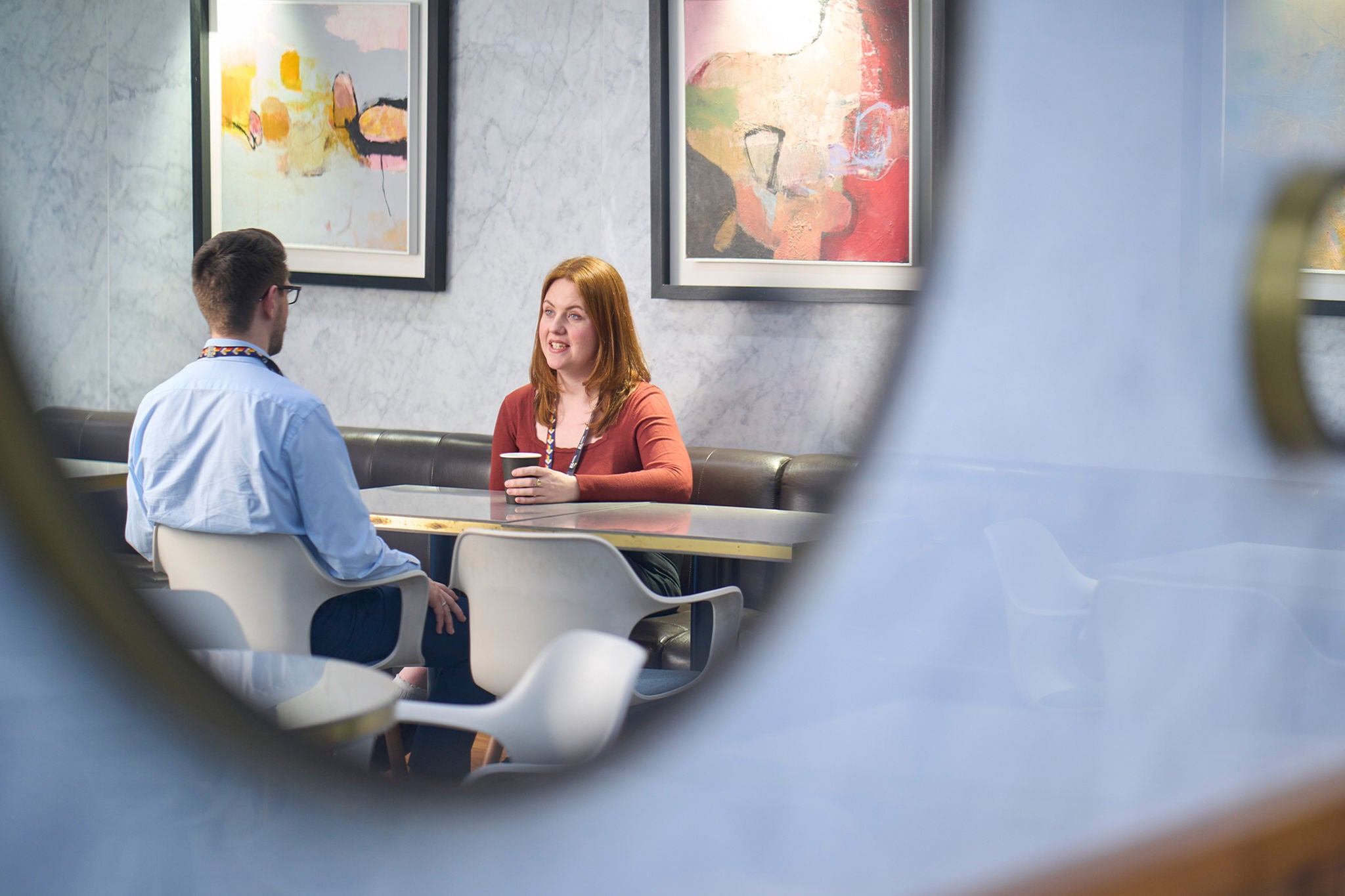 two persons are talking in the office