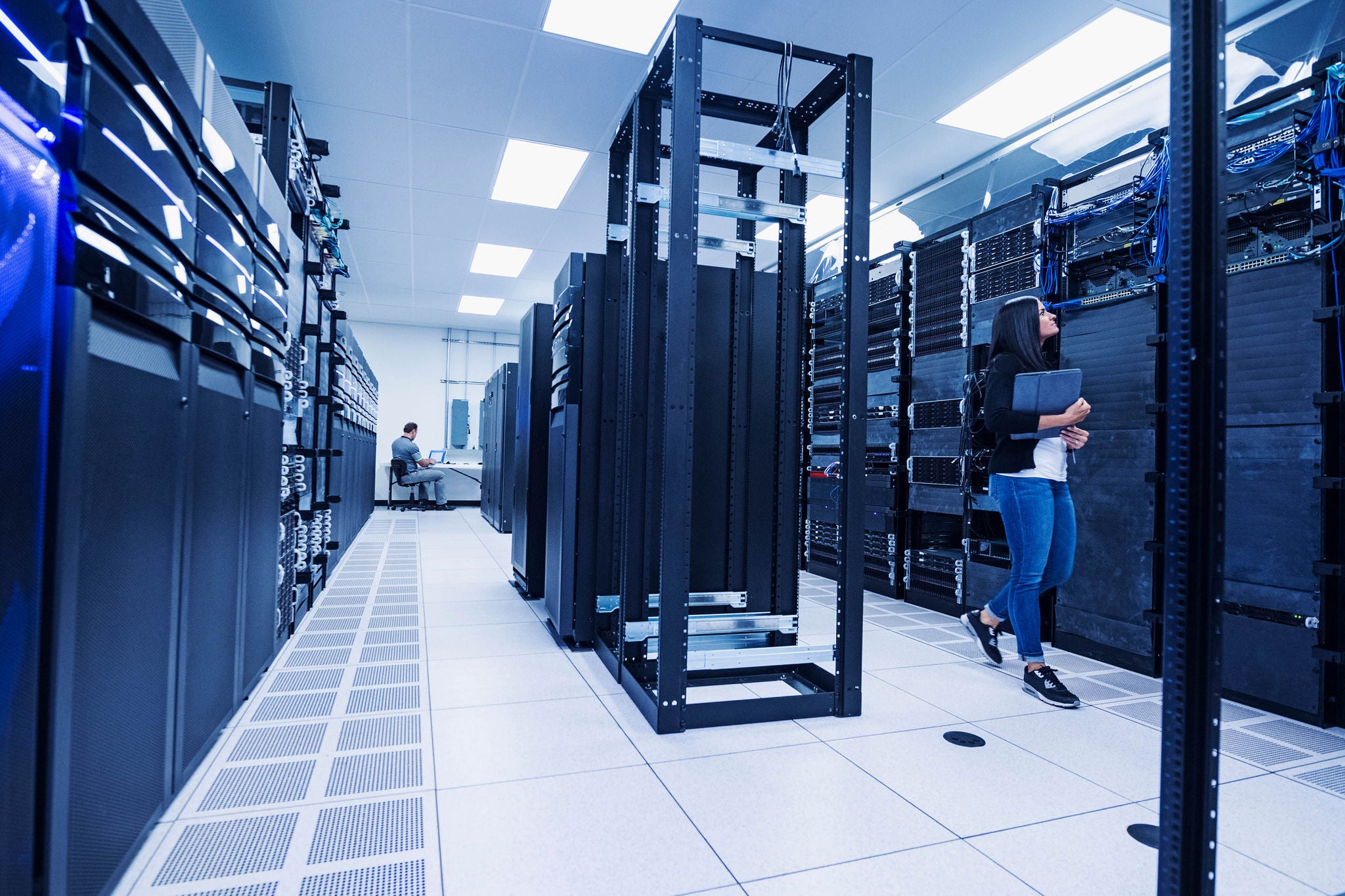 Woman and man working in server room