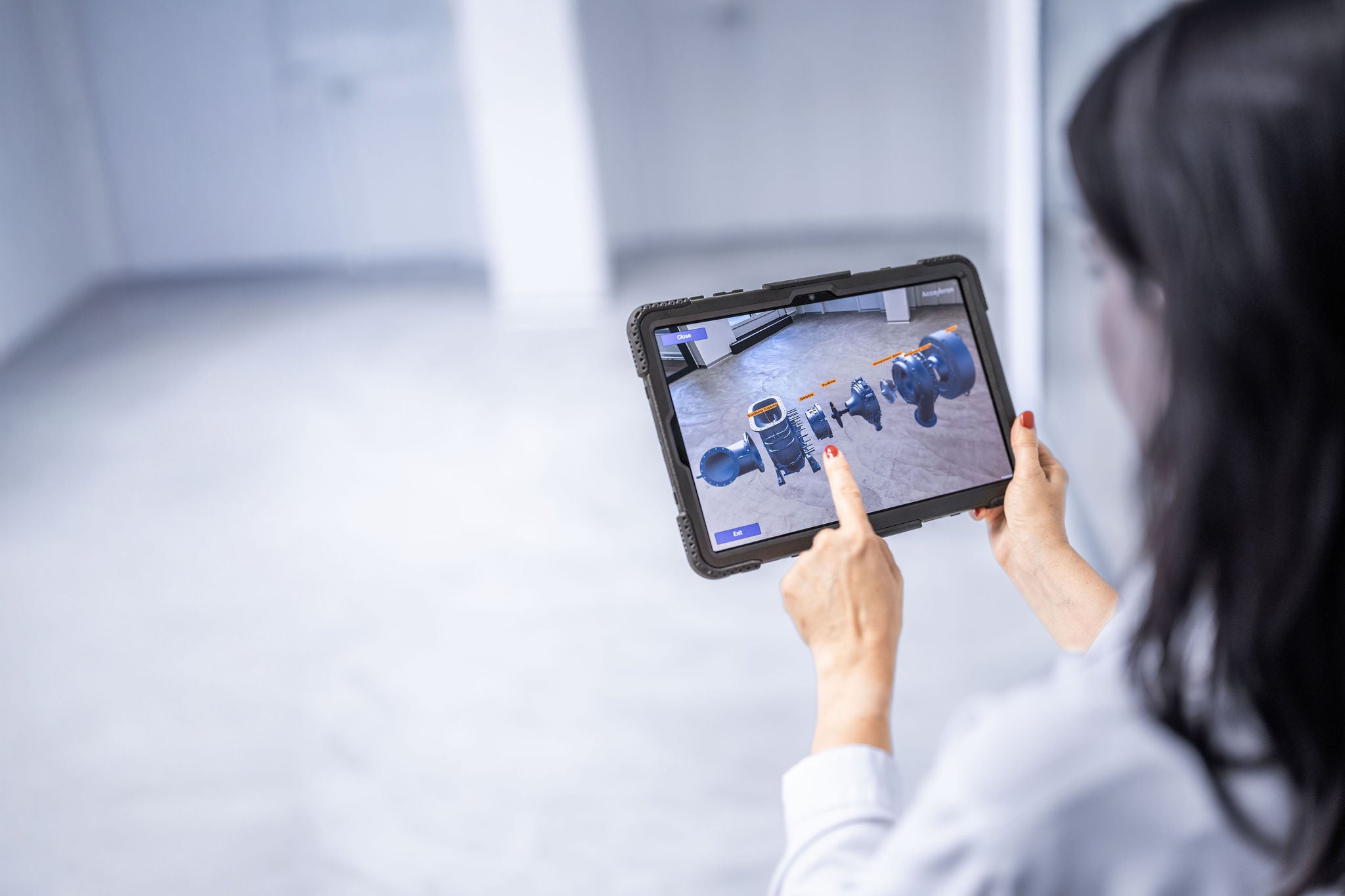 Woman uses tablet computer in acceleron factory baden