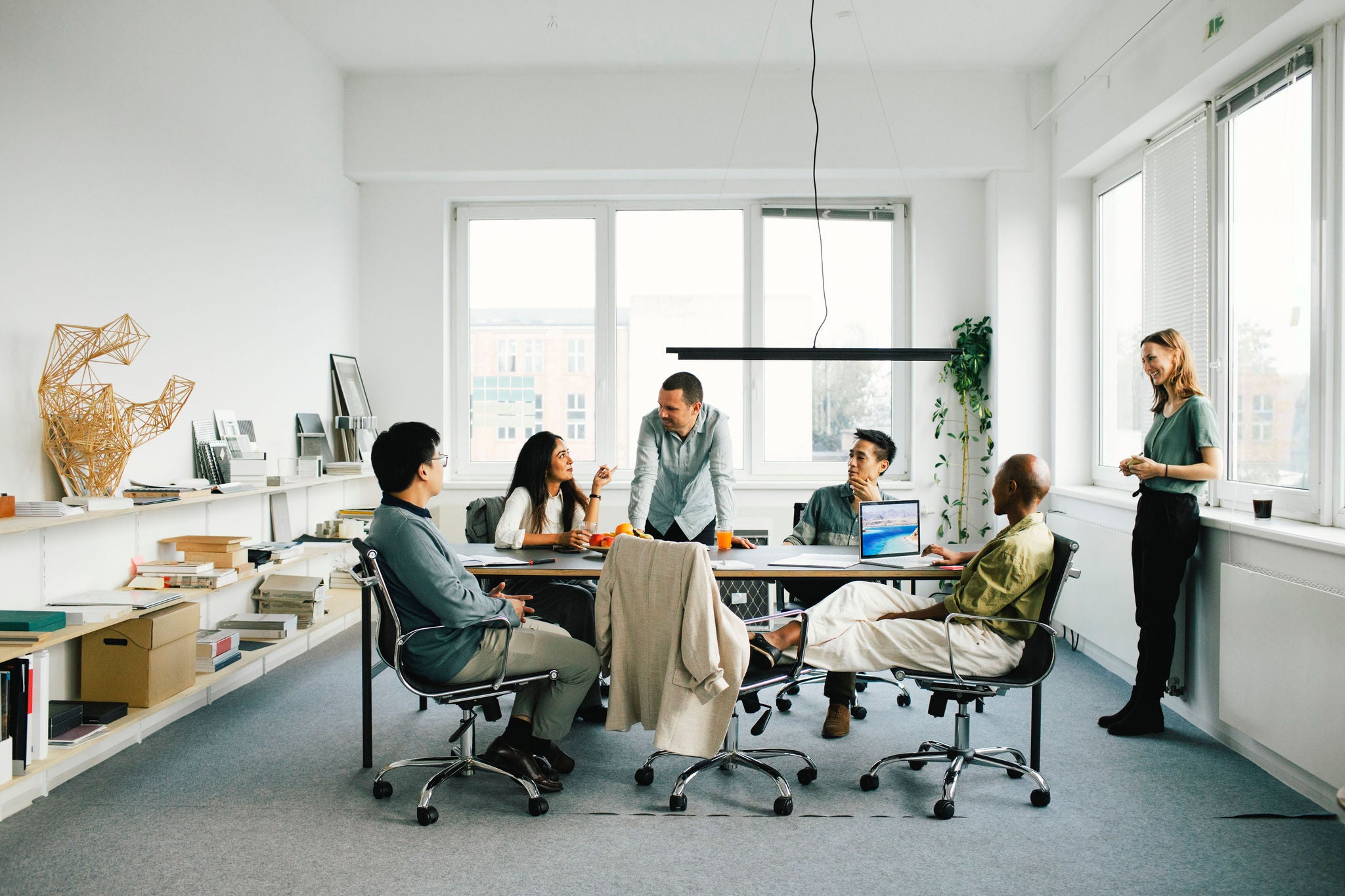 Multiracial business professionals discussing in meeting at office