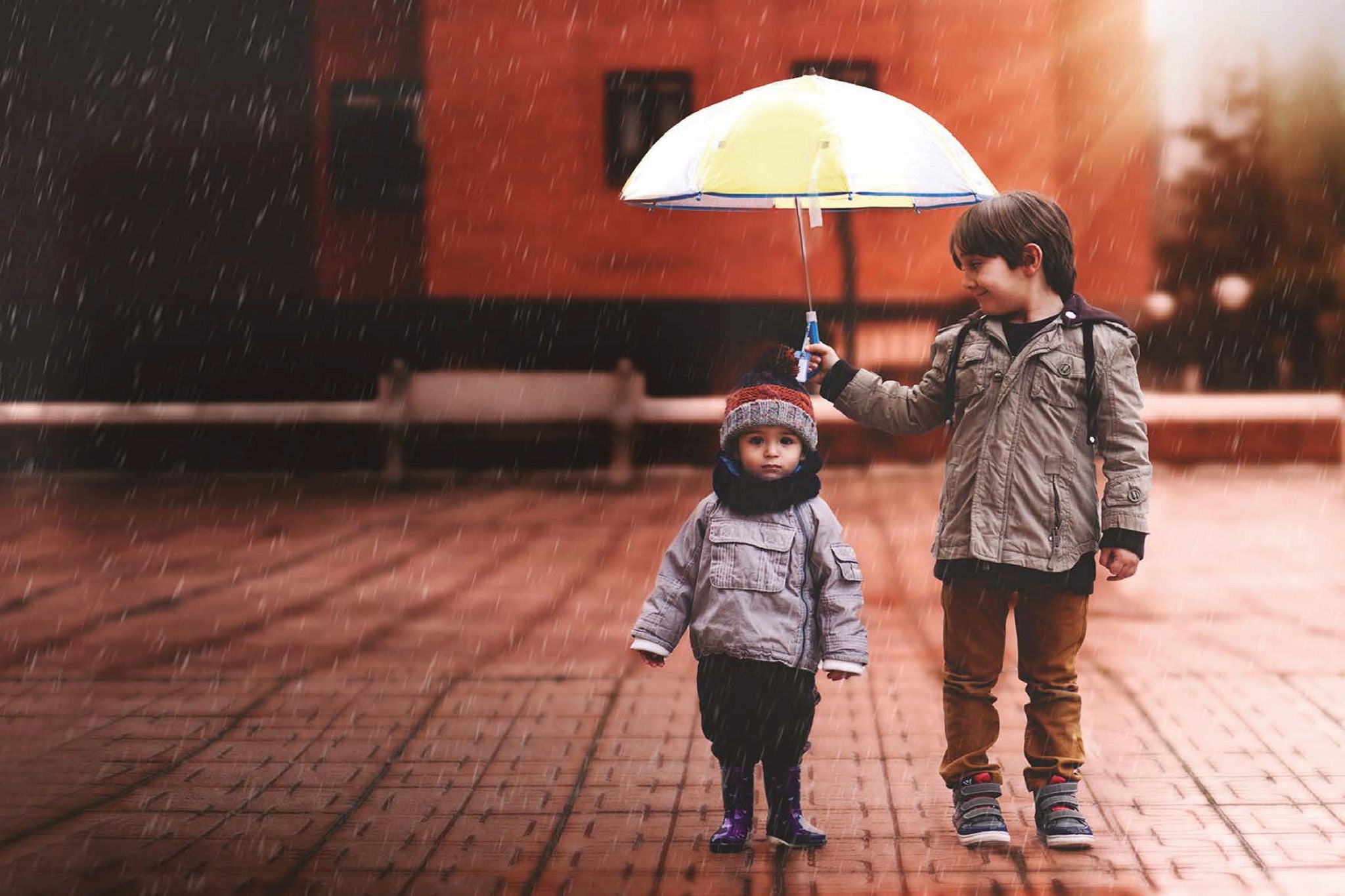 Brother holding umbrella 