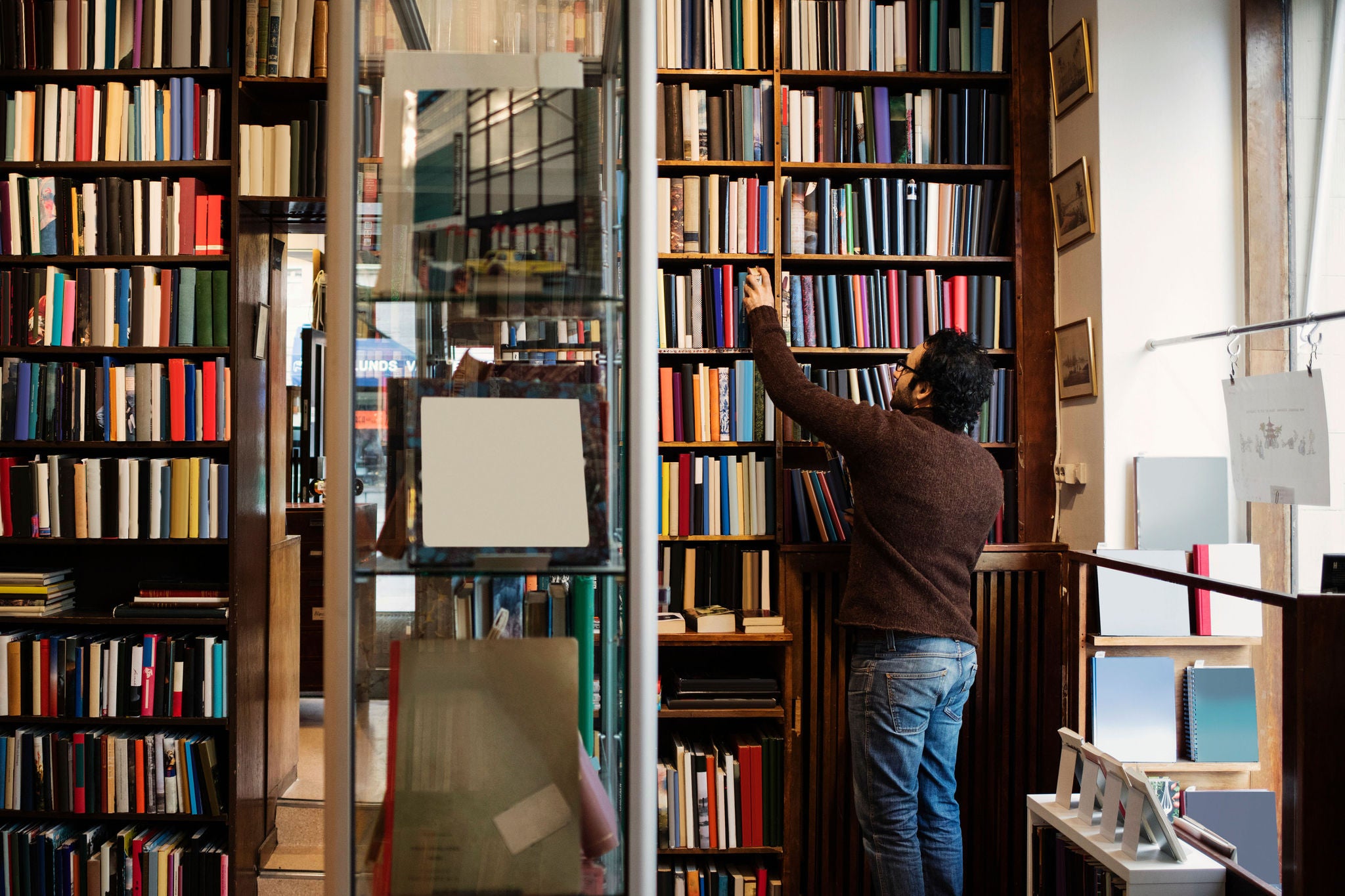 man searching book antique library