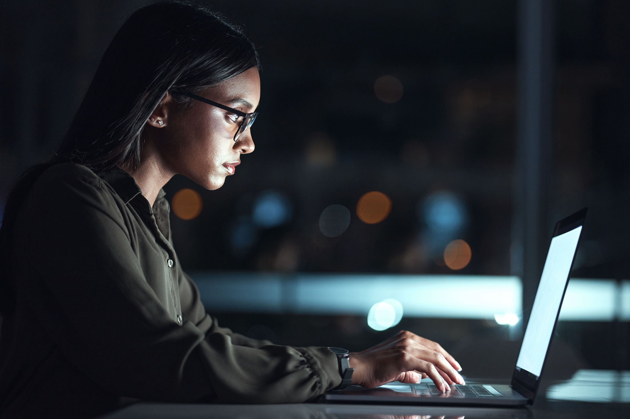 Laptop, research and business woman in coding, software development and programming for night cybersecurity. Computer, typing and screen reflection, focus and data analysis of programmer or IT person