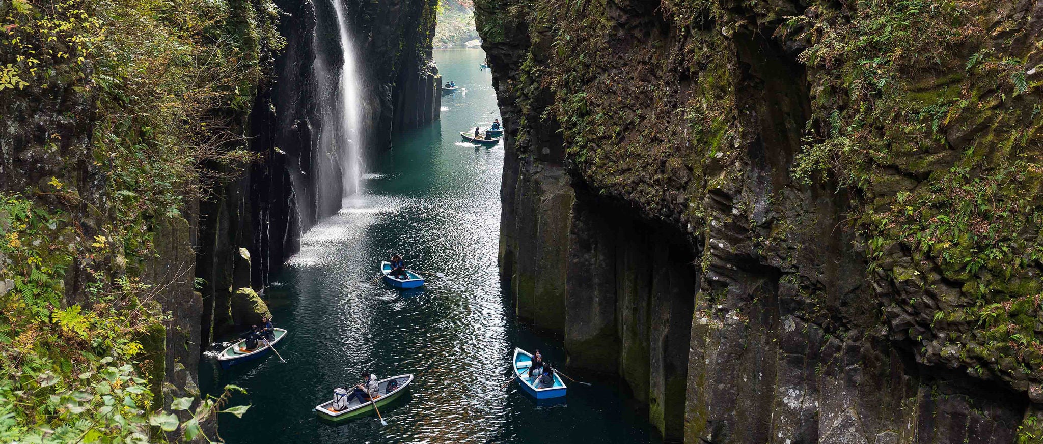 People in rowing boats in Takachiho Gorge in Japan