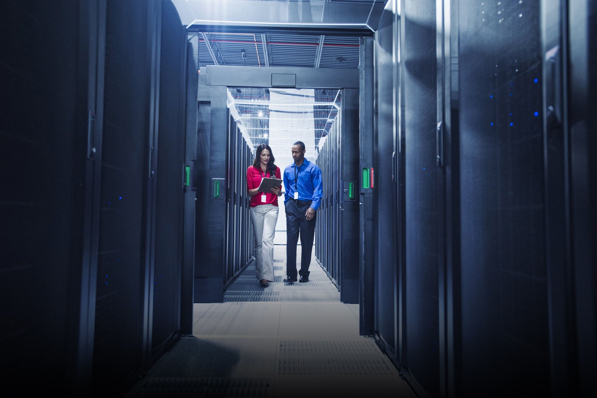 People discussing in data centre room