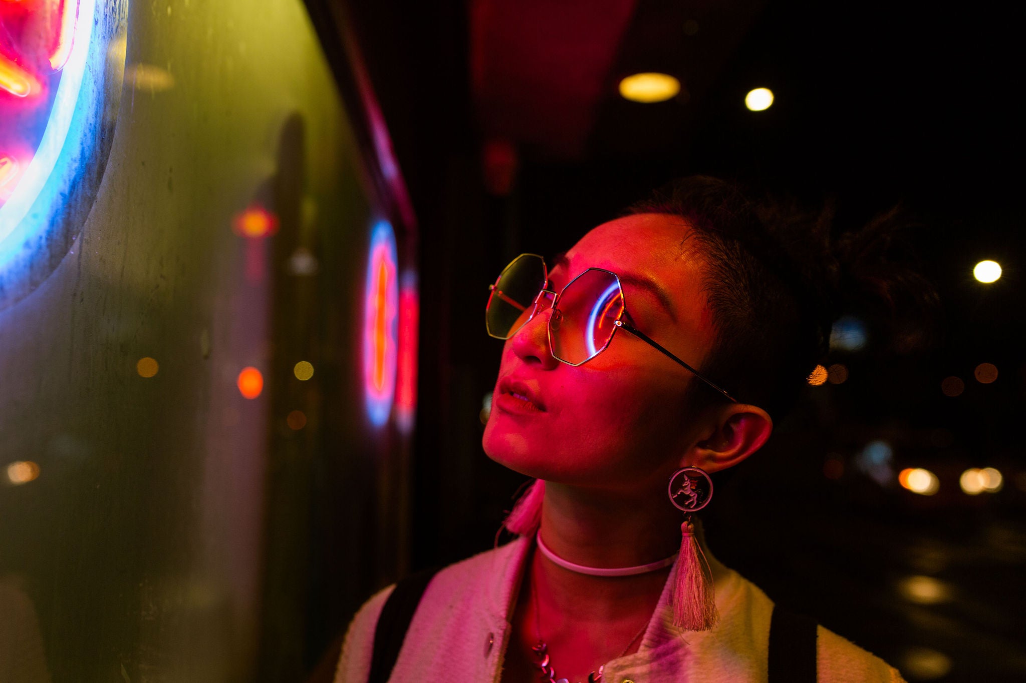 Portrait of young woman under neon light