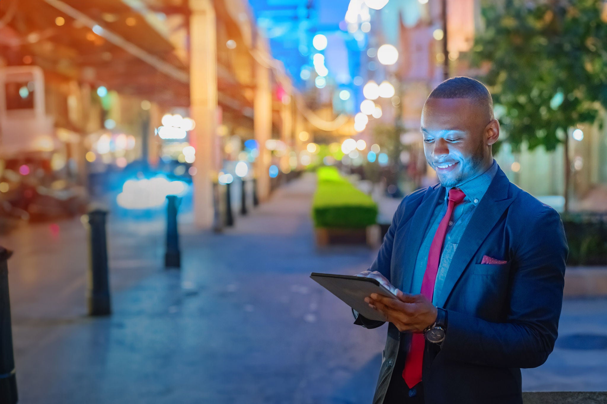 Businessman in the city looking into digital tablet computer