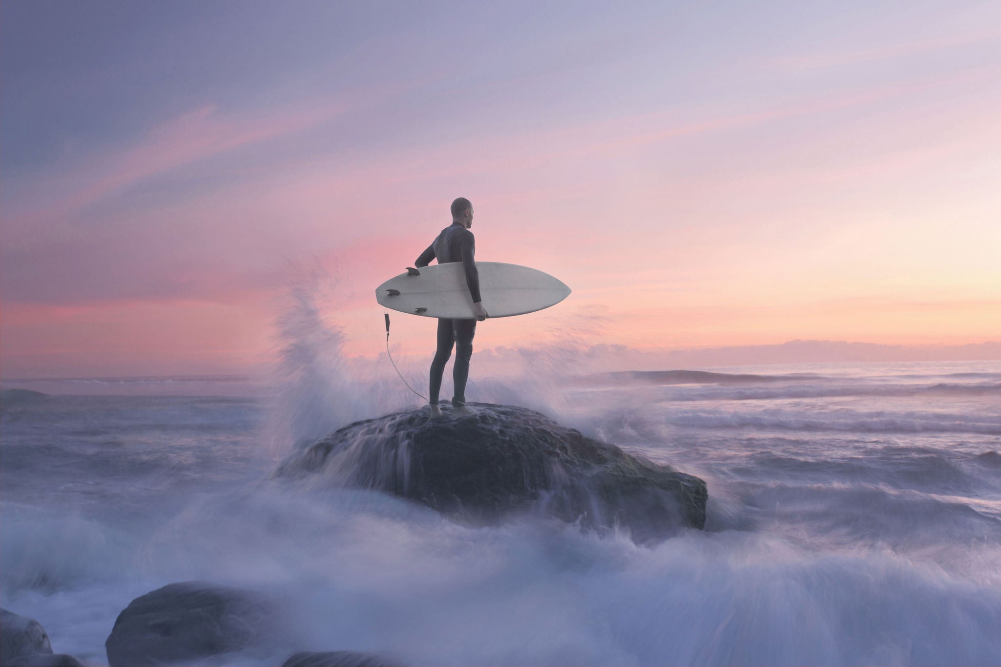 Male surfer rock waves