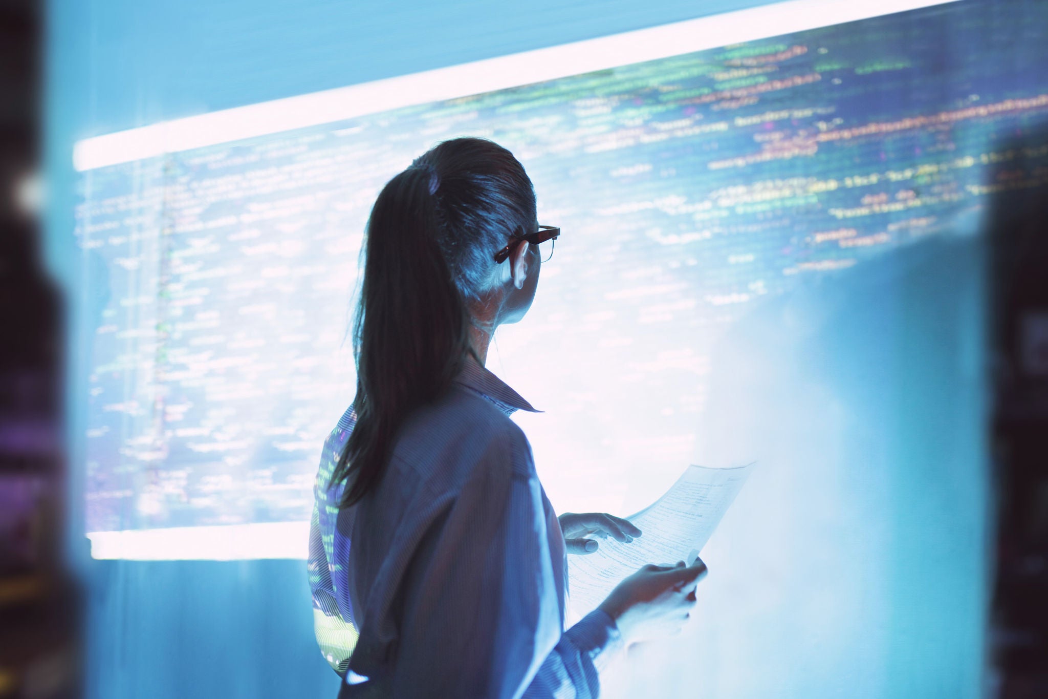 Woman looking at wall with code