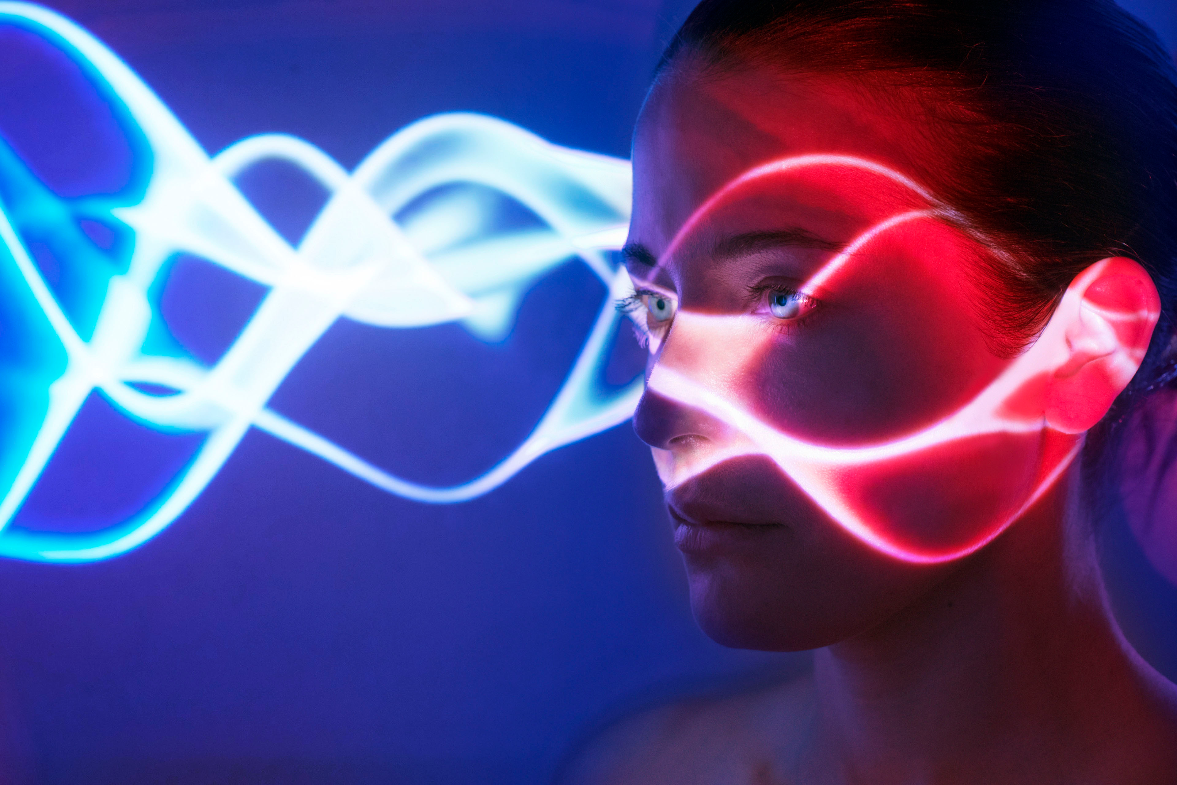 ey-woman-with-lights-on-face-blue-background