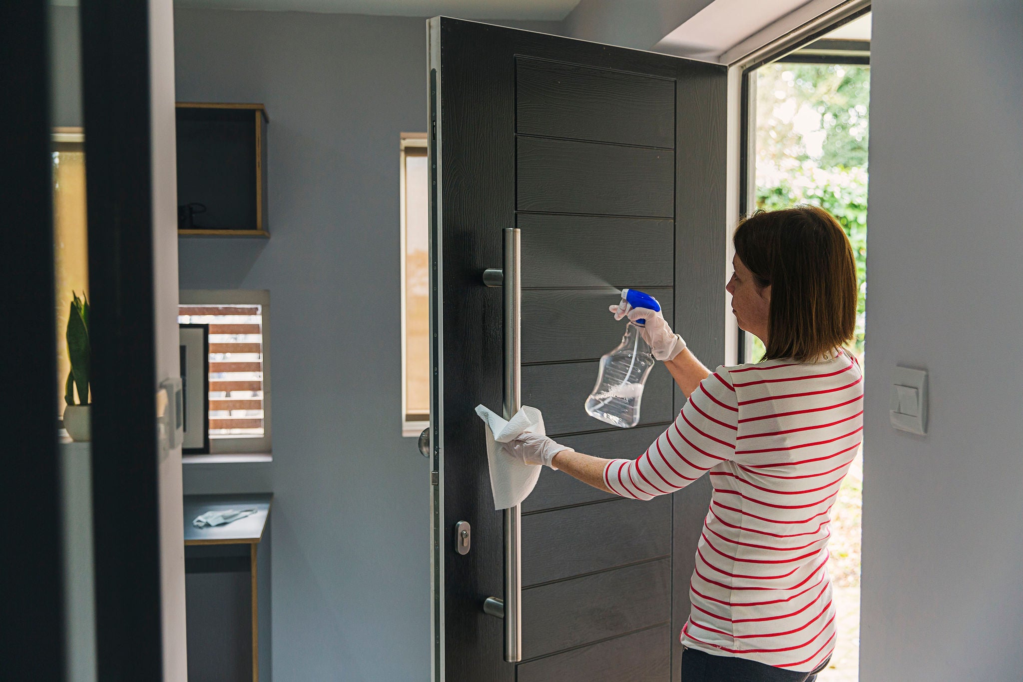 Woman cleaning front door