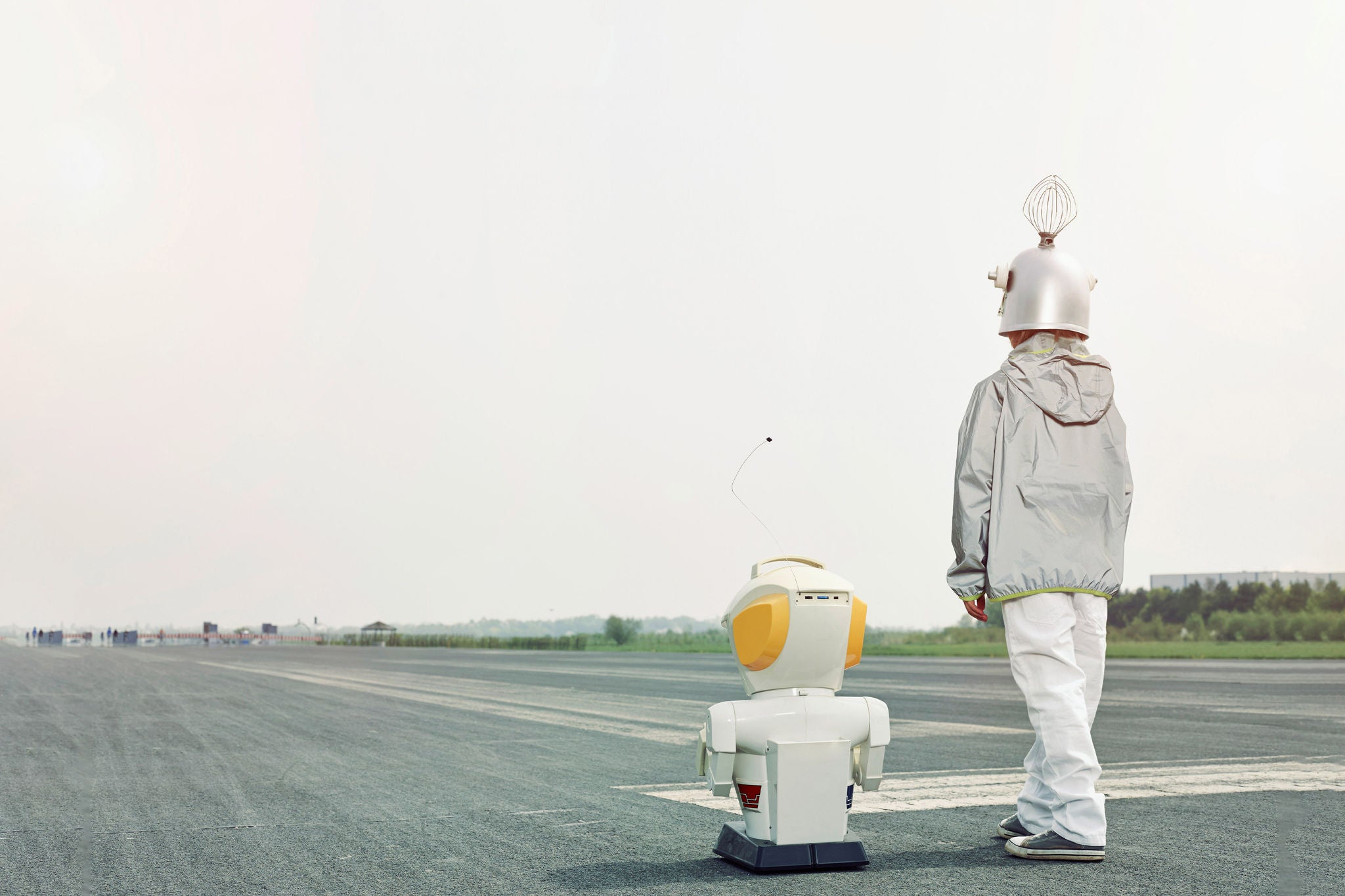 Boy dressed up as spaceman with robot