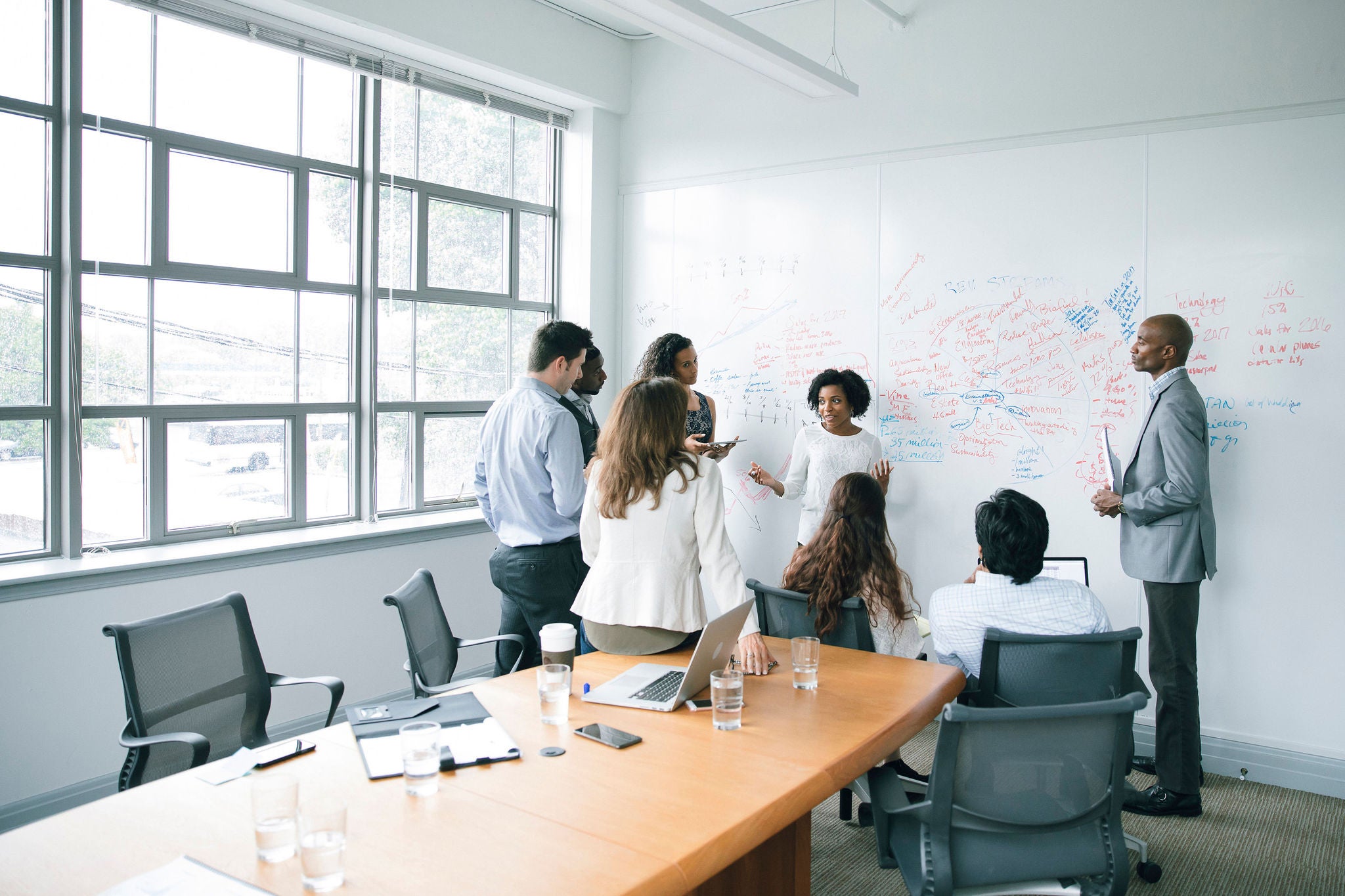 Businesswoman talking near whiteboard in meeting