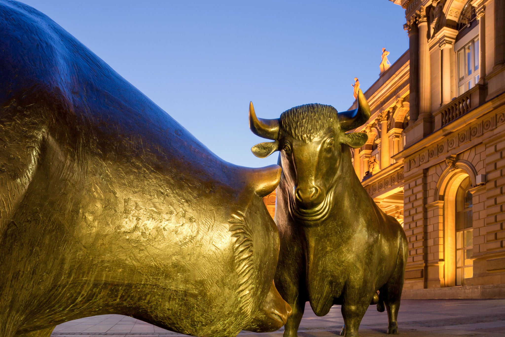 Bull and Bear in front of the Frankfurt Stock Exchange (DAX) at dusk