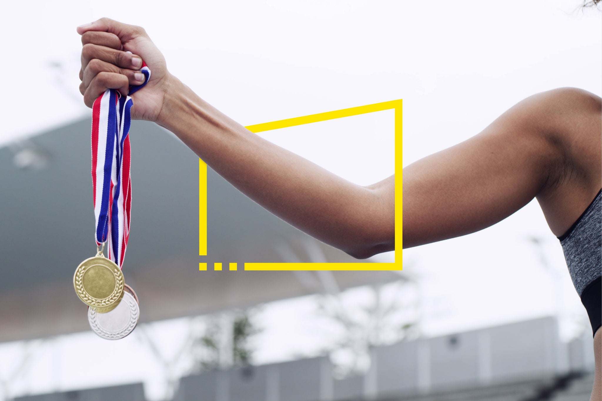 A person holding up three medals