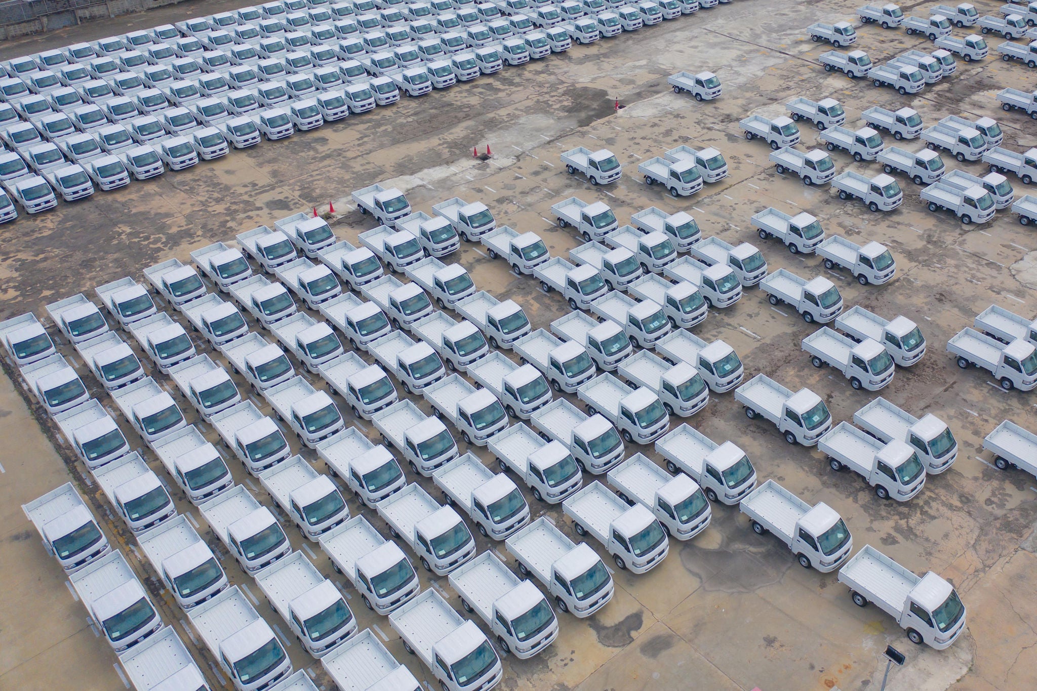 Aerial top view of new truck cars parking for sale stock lot row, dealer inventory import and export business commercial, Automobile and automotive industry distribution logistic global transport
