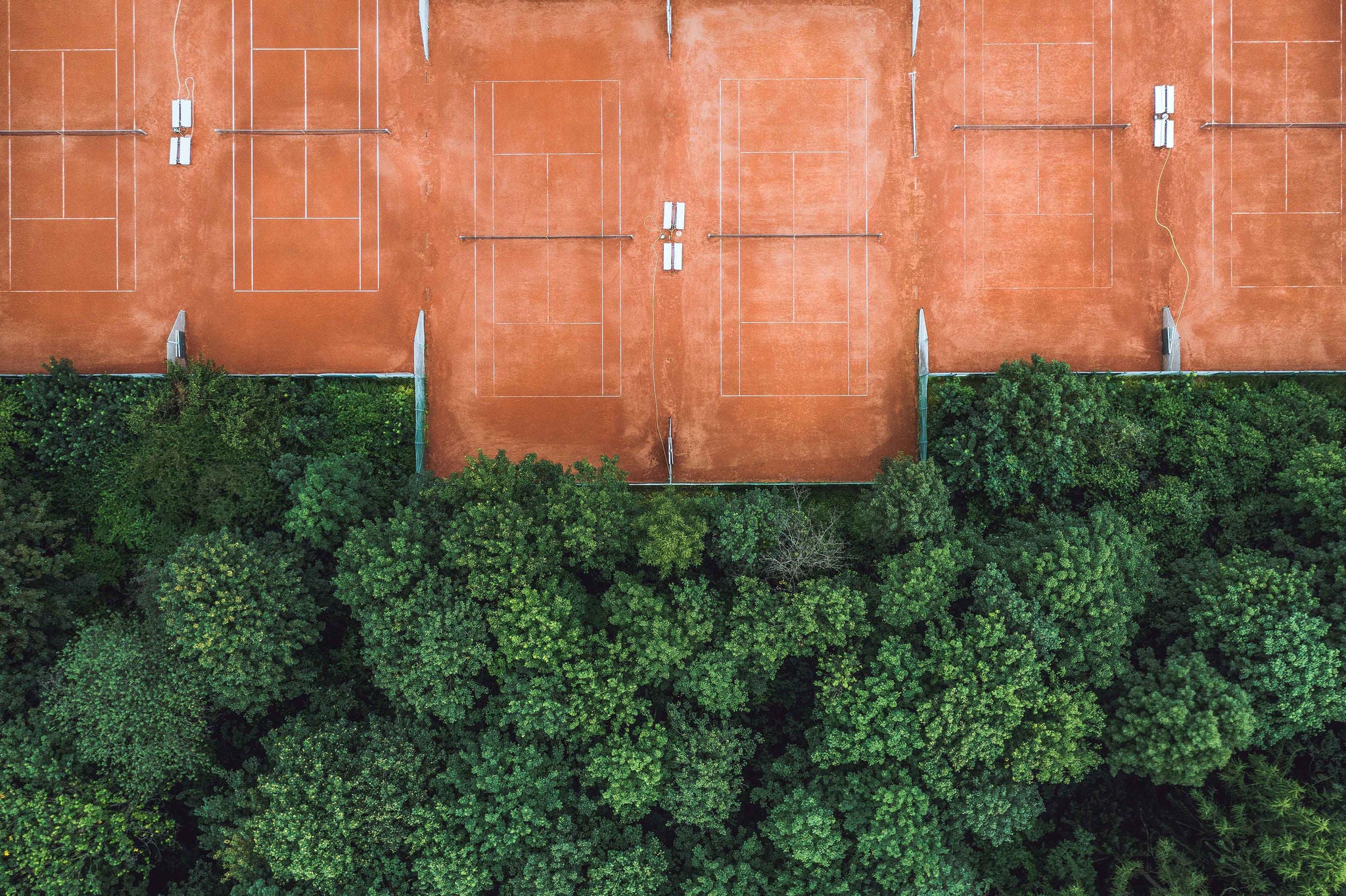 CEO Outlook January 2024 On Transformation Strategy EY Global   Ey Aerial Shot Of Tennis Courts At The Edge Of A Forest 