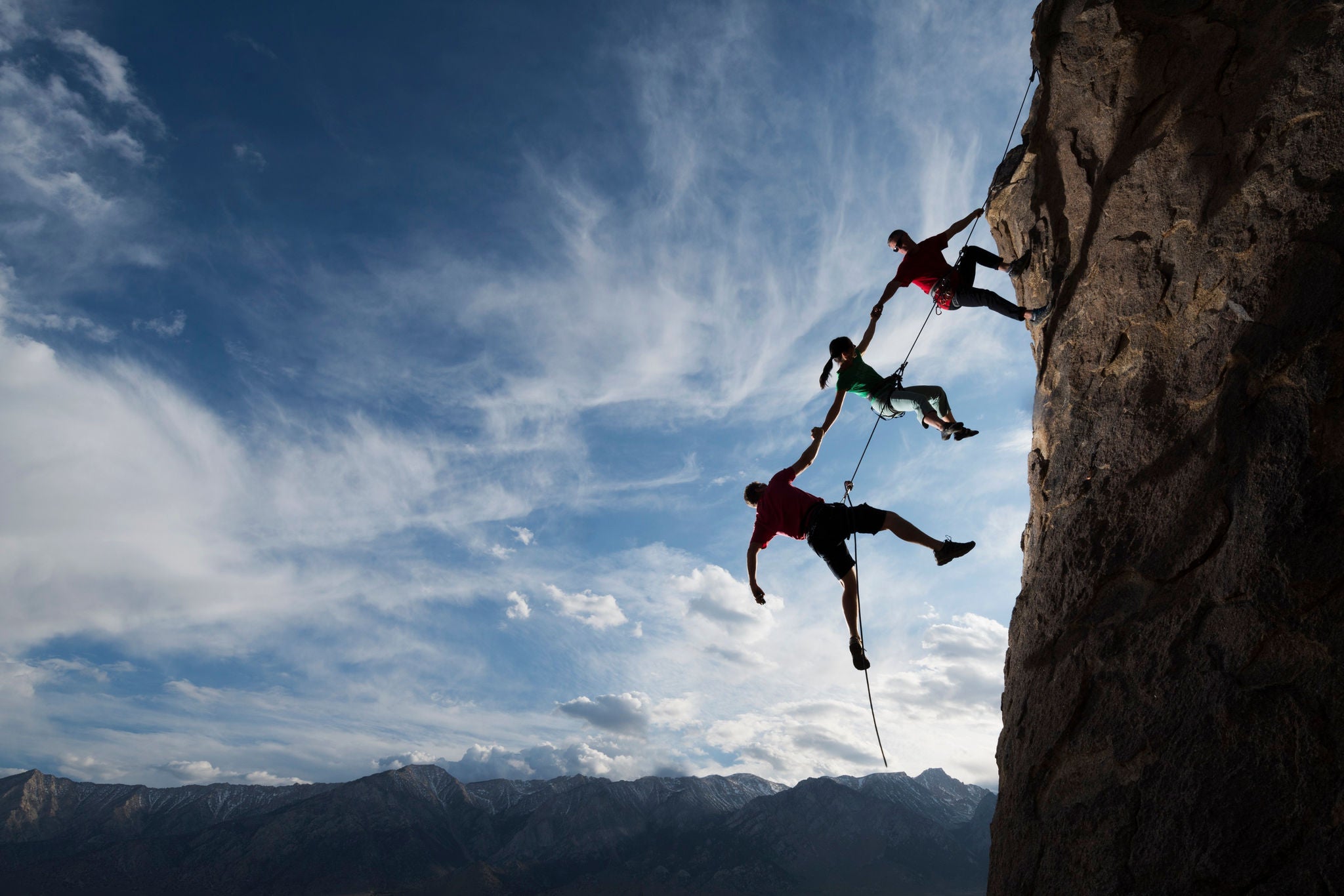 People climbing up a rock