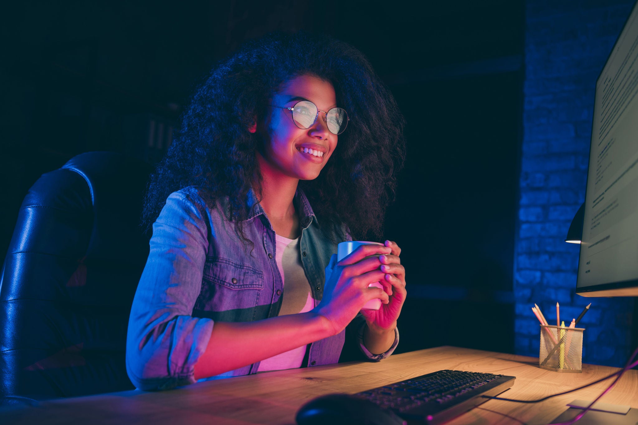 Profile photo of business woman in the glow of her screen monitor.