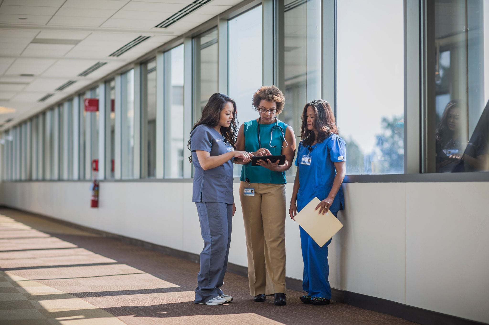 Nurses and doctor using digital tablet