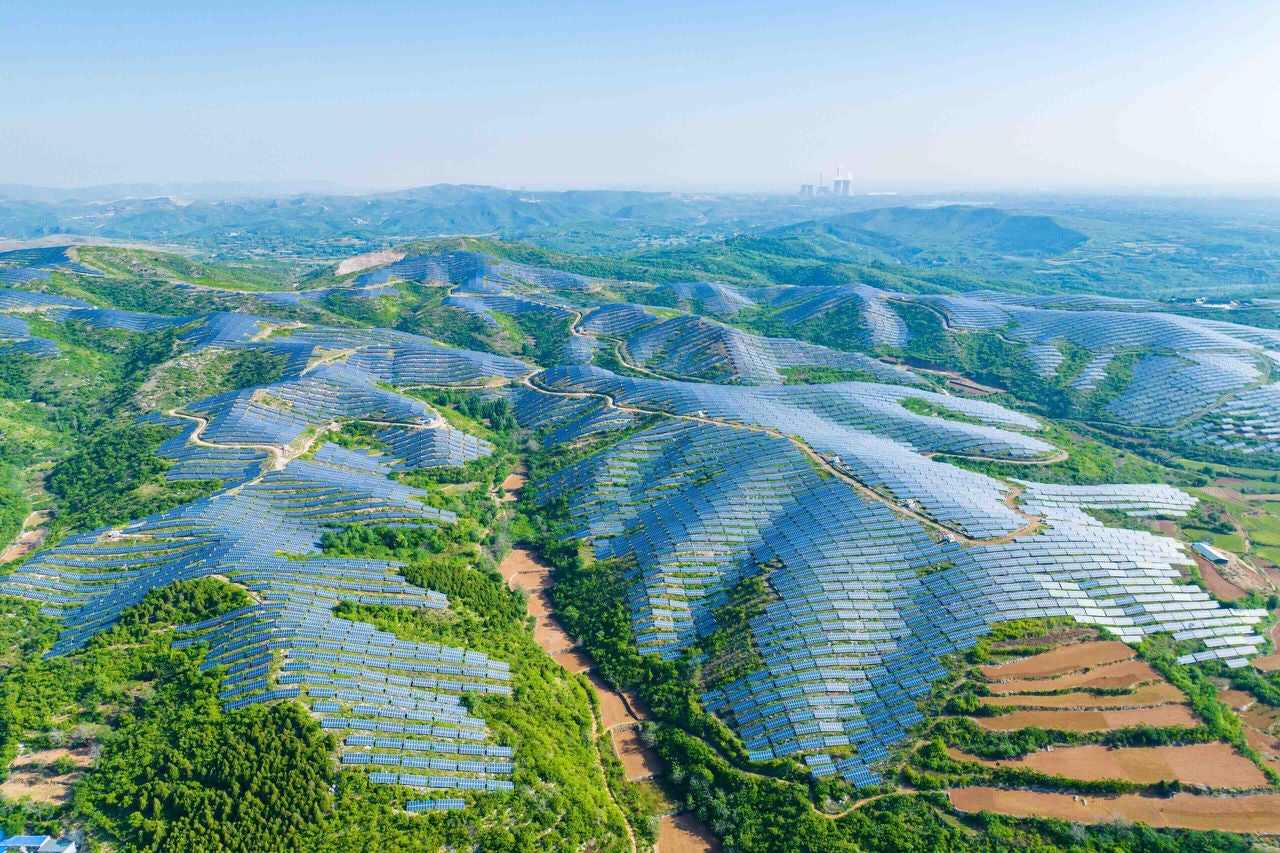 Aerial view of solar panels on the top of the mountain