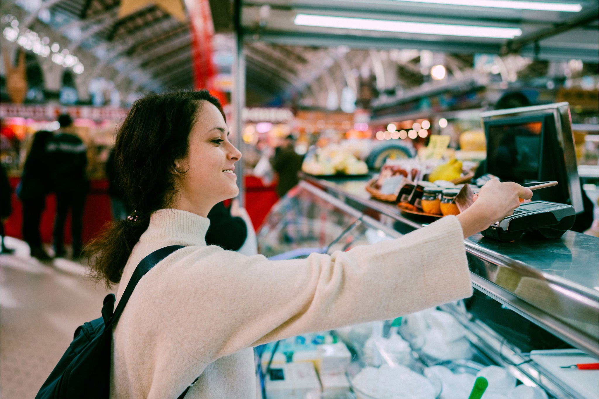 Women making cotactless transaction through mobile