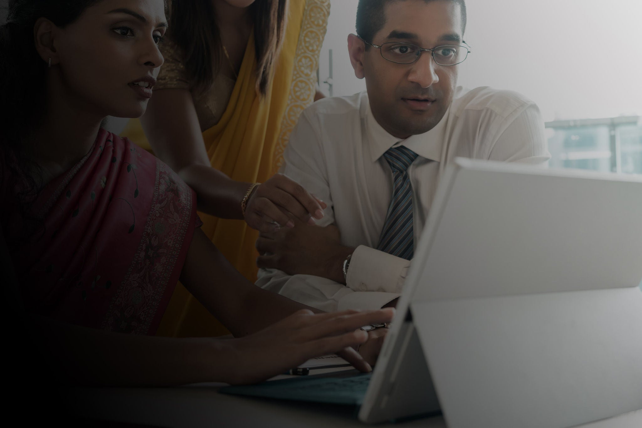 Team members discussing while working on system