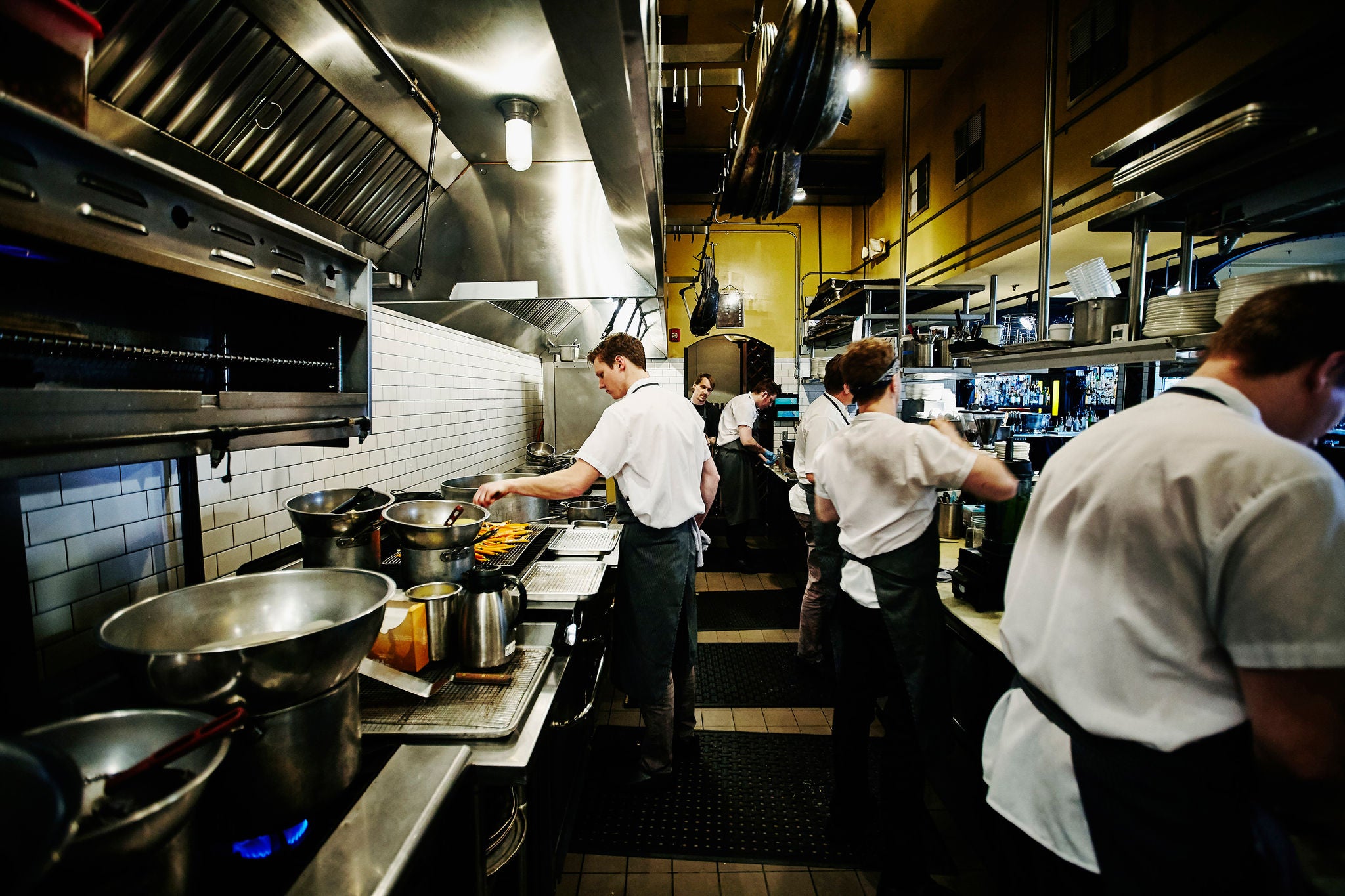 Chef and kitchen staff preparing dinner in restaurant kitchen