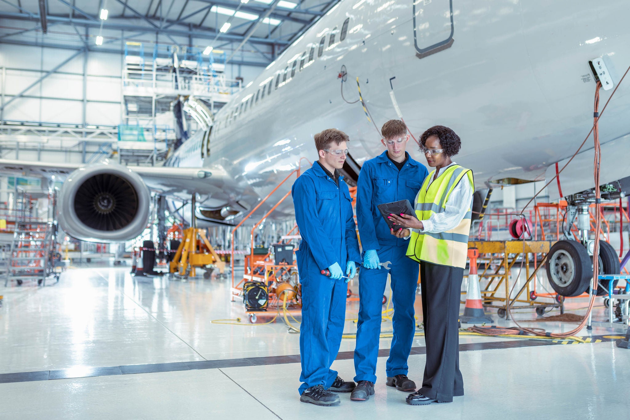 Apprentice aircraft maintenance engineers with supervisor