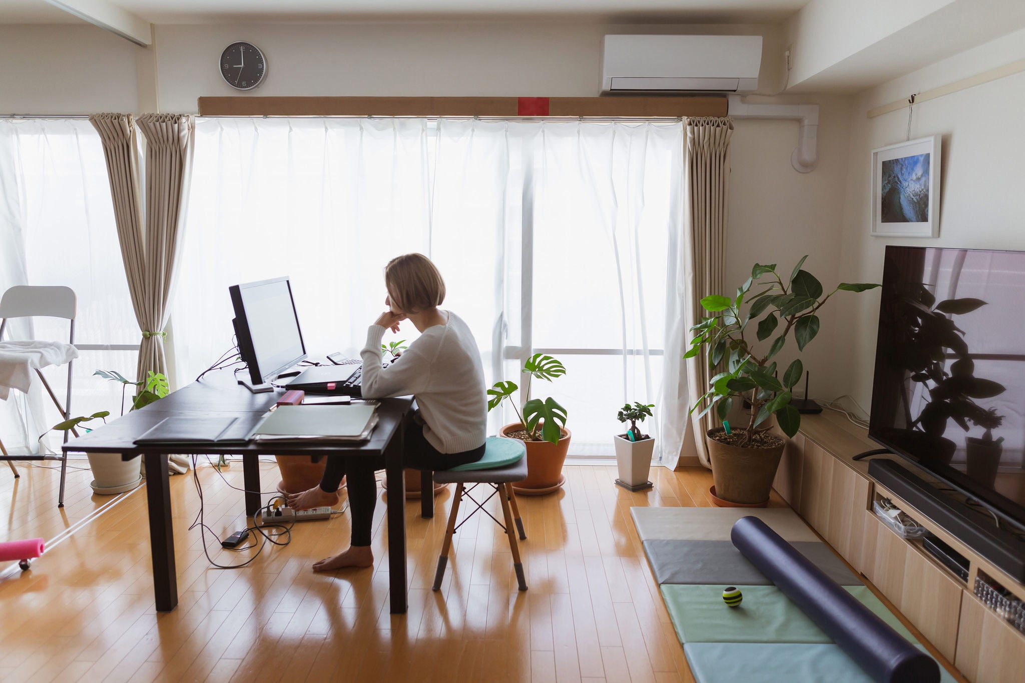 ey woman using a computer in the living room