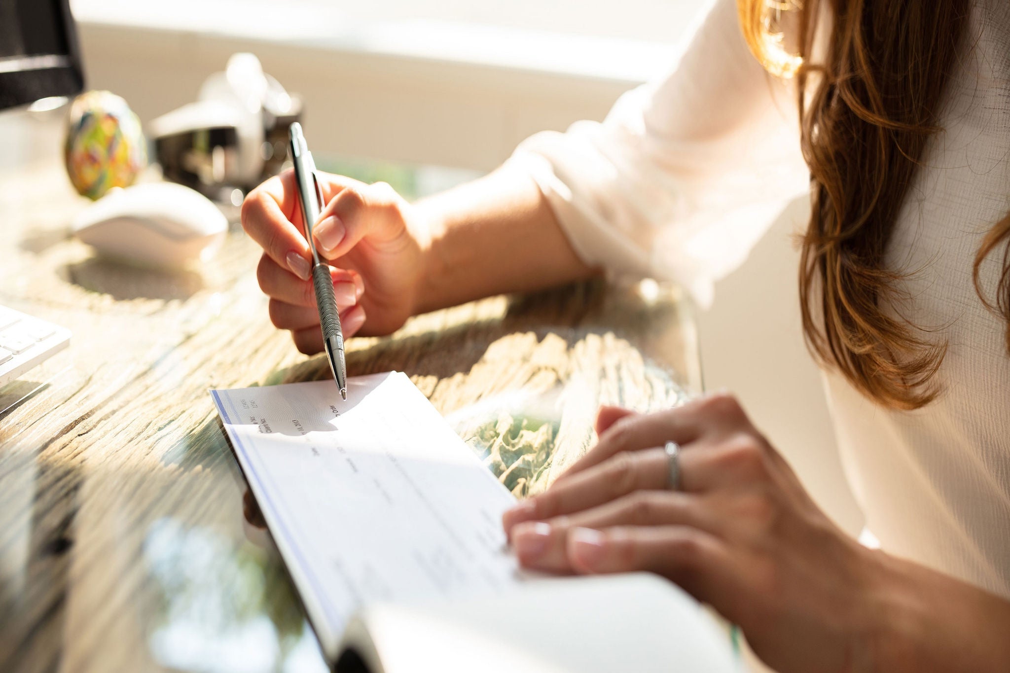 Businesswomans signing check