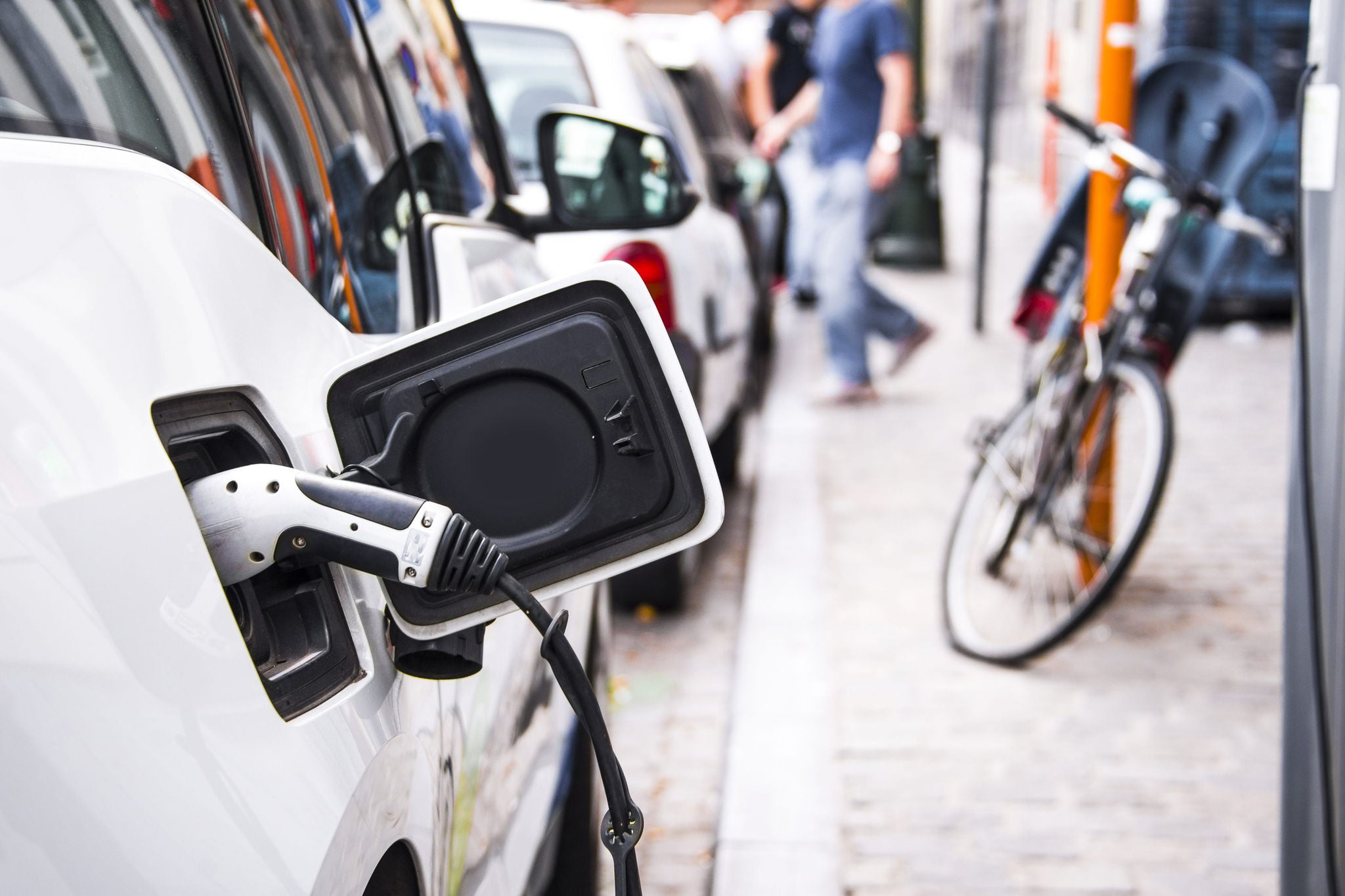 An electric car is recharging at the charging station