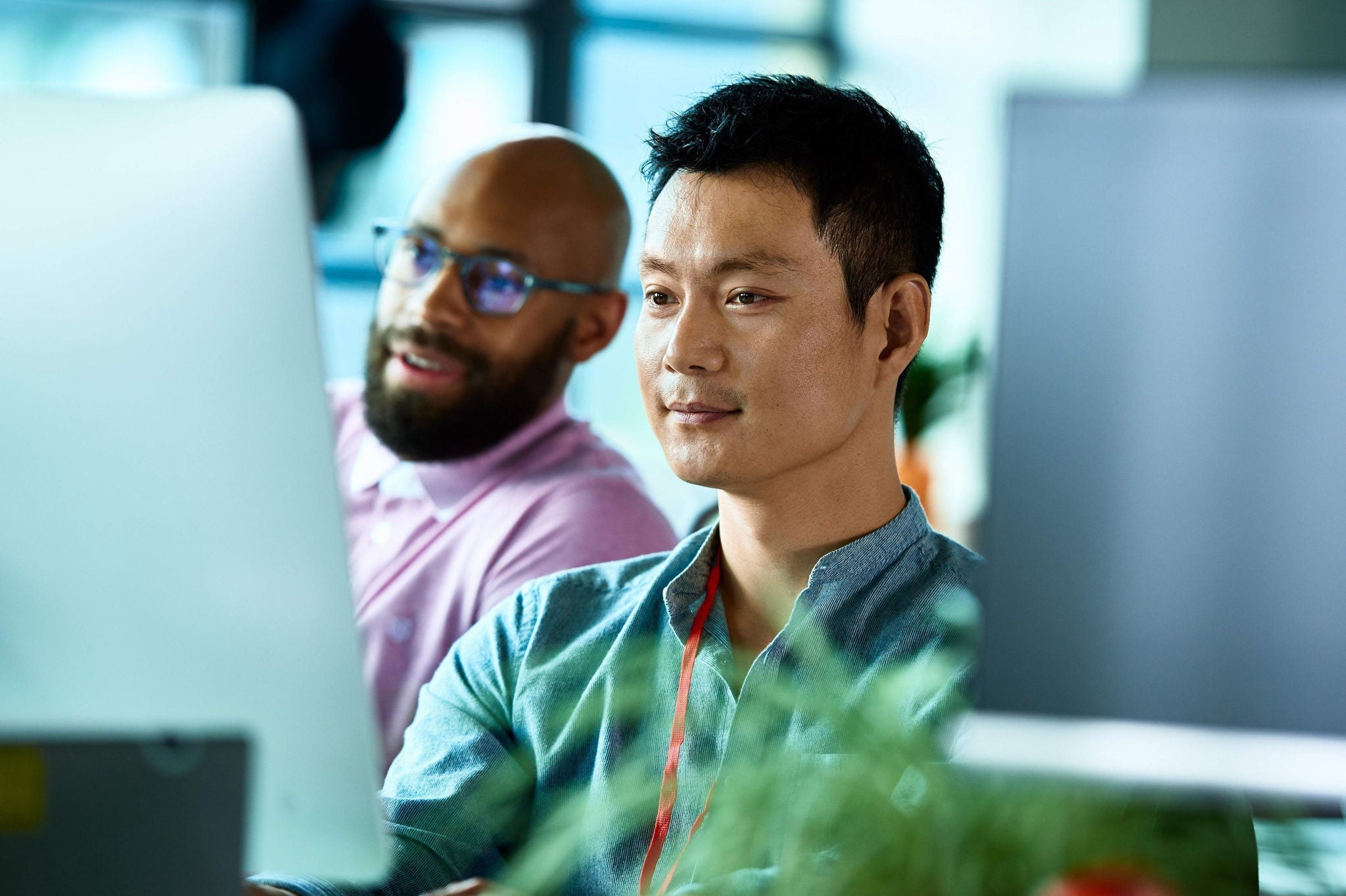 Co-workers looking at computer screen