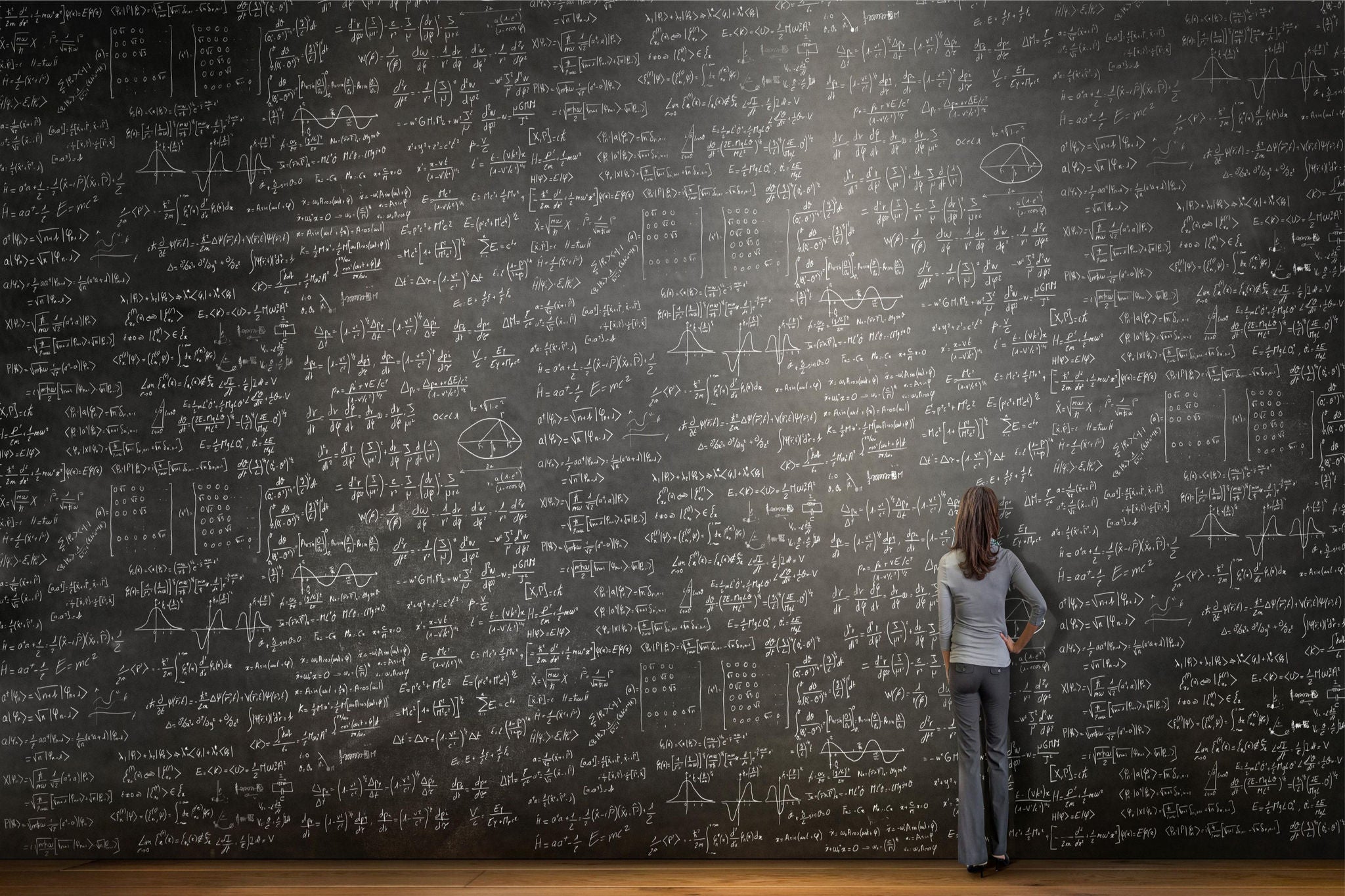 Women standing infront of large black board