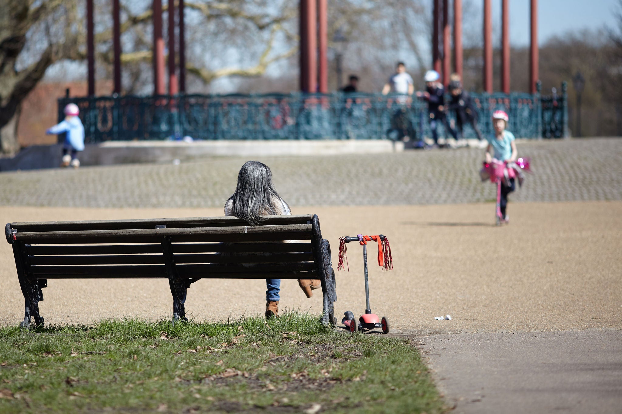 a mother watches her child in the park 